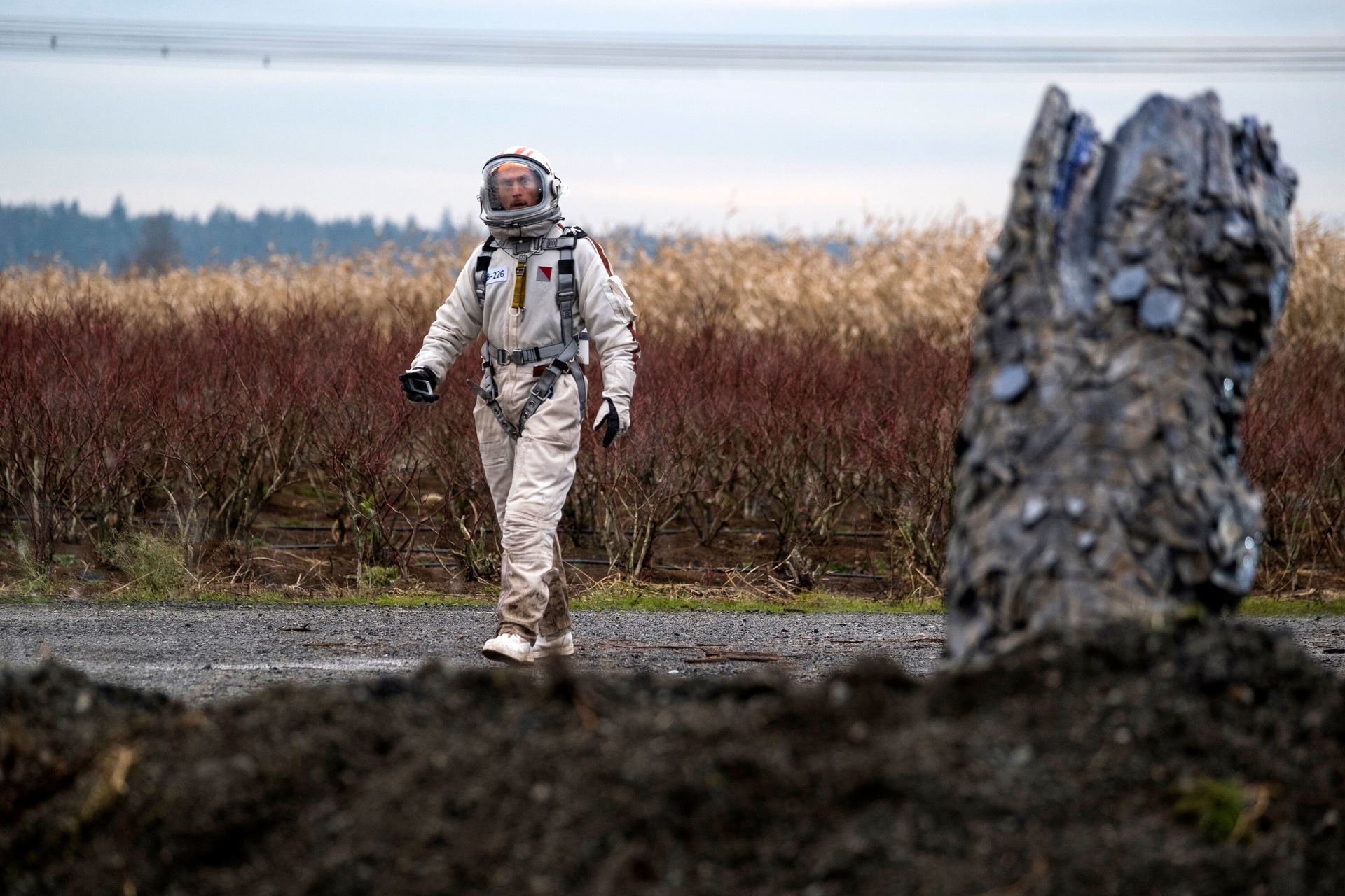 Astronaut walking in a field HD Wallpaper