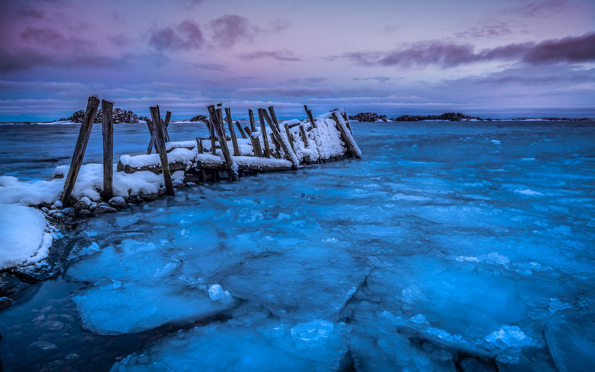 Frozen pier with ice and snow at dusk HD Wallpaper
