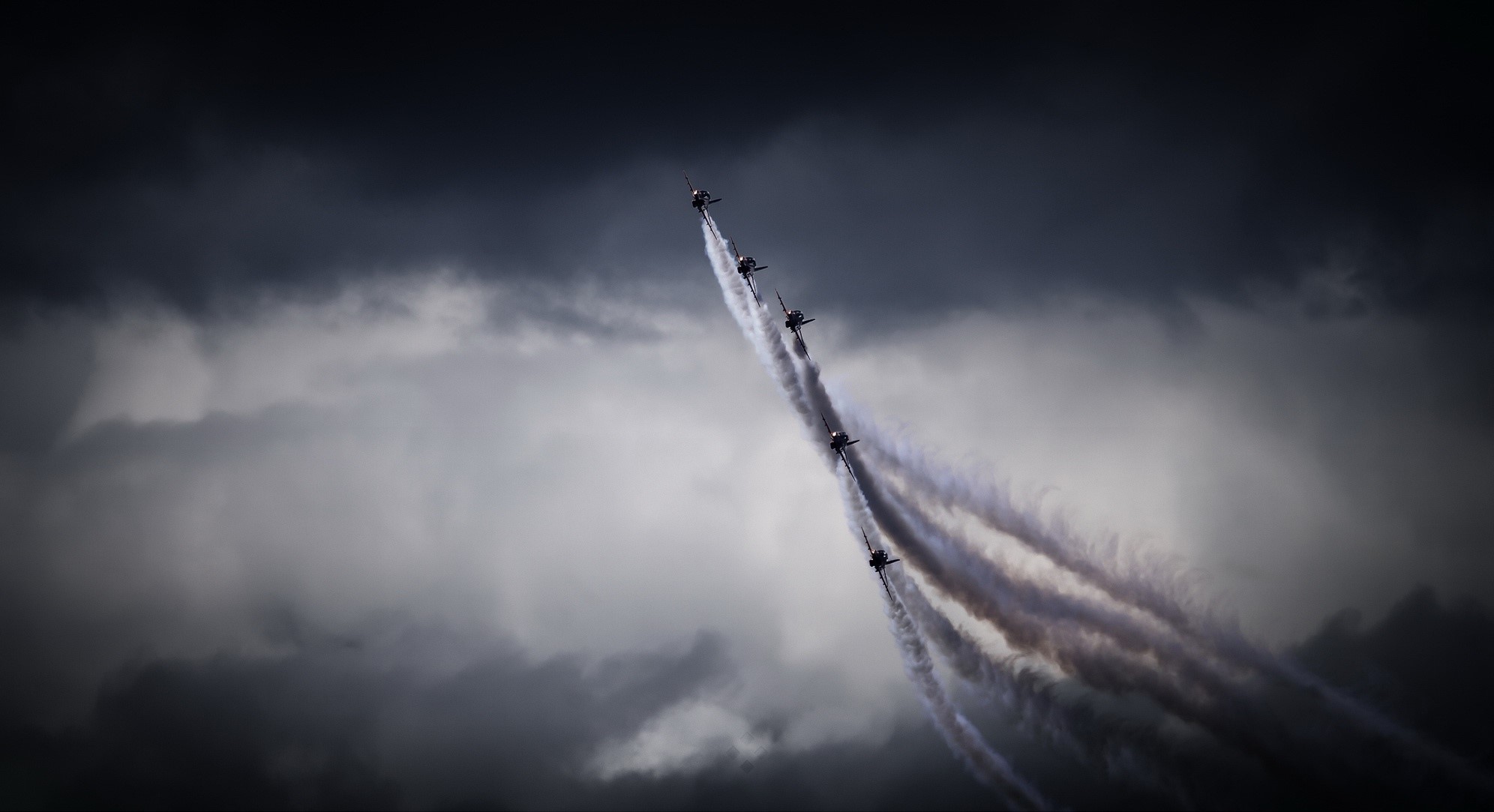 Red Arrows formation flying through dark clouds HD Wallpaper