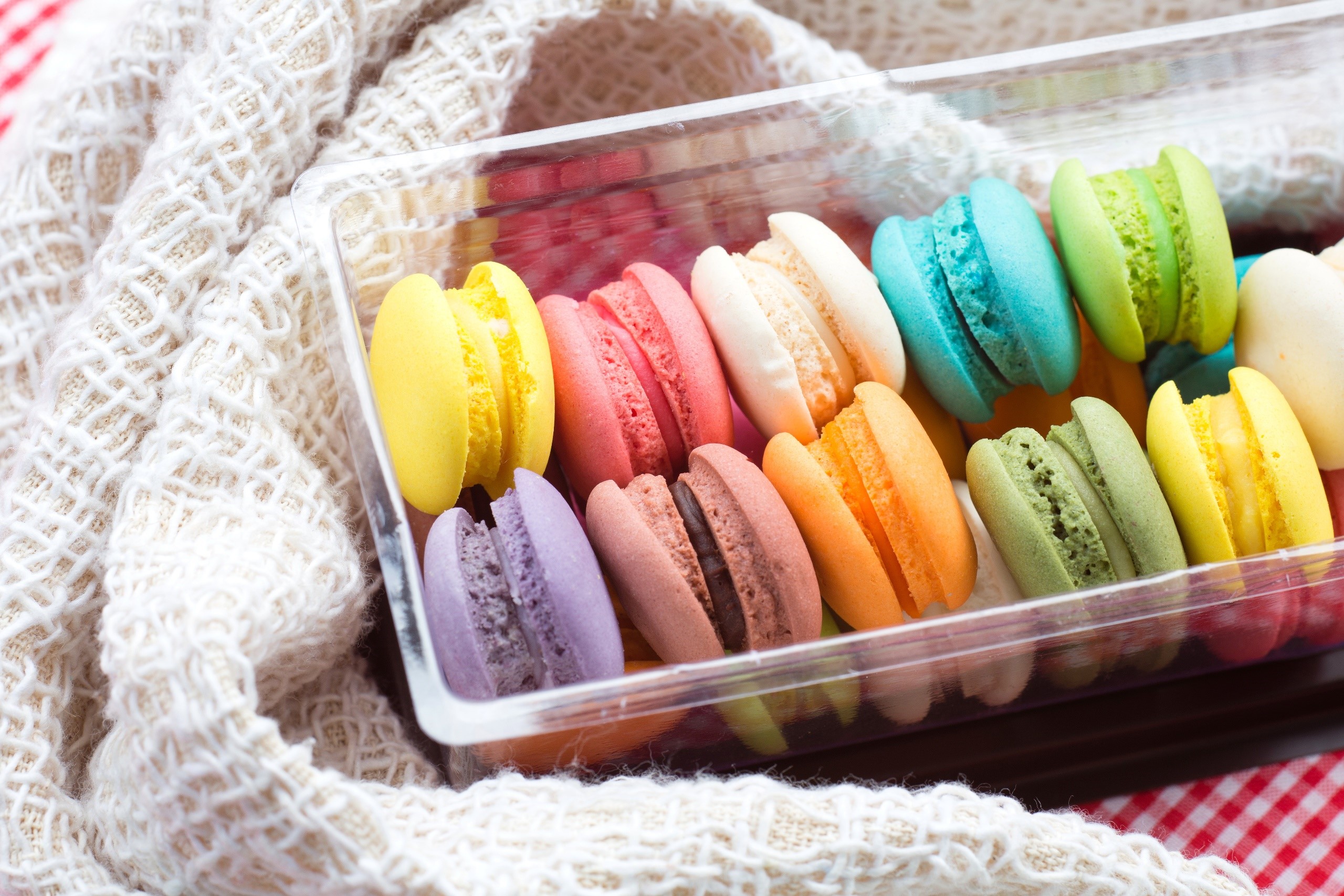 Colorful macarons in a clear plastic box HD Wallpaper
