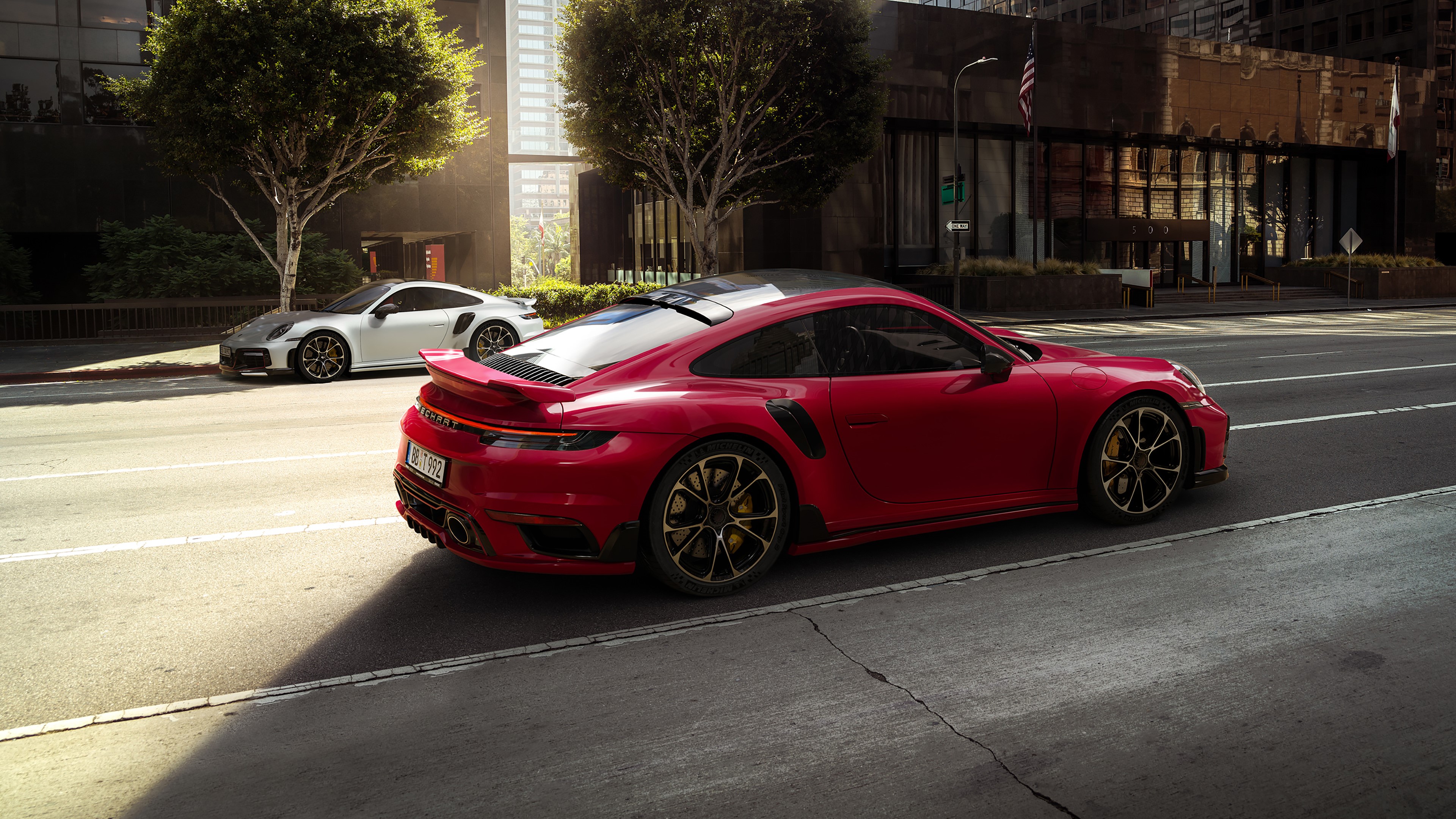 Red and white Porsche 911 sports cars on urban street HD Wallpaper