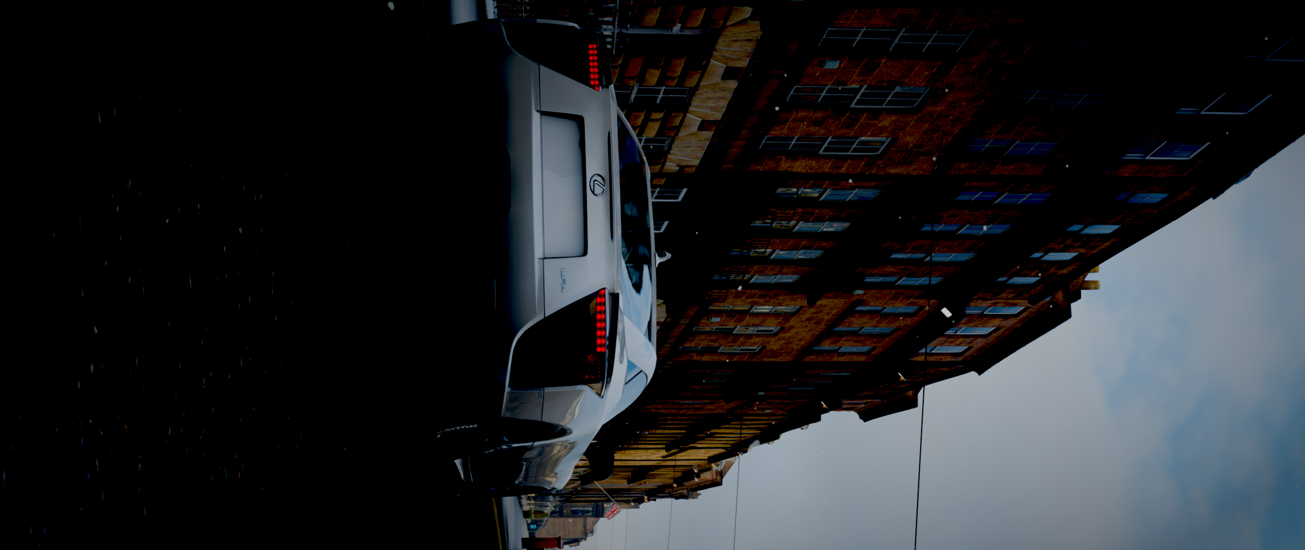 Car parked on a street with buildings HD Wallpaper