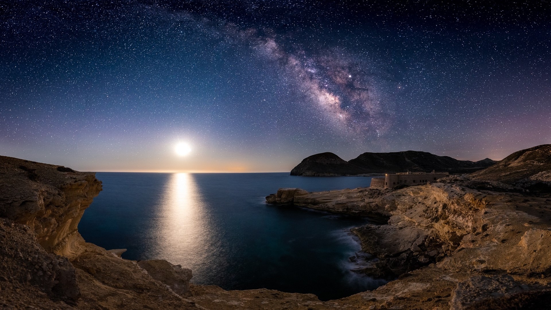 Milky Way over the sea and castle at night HD Wallpaper
