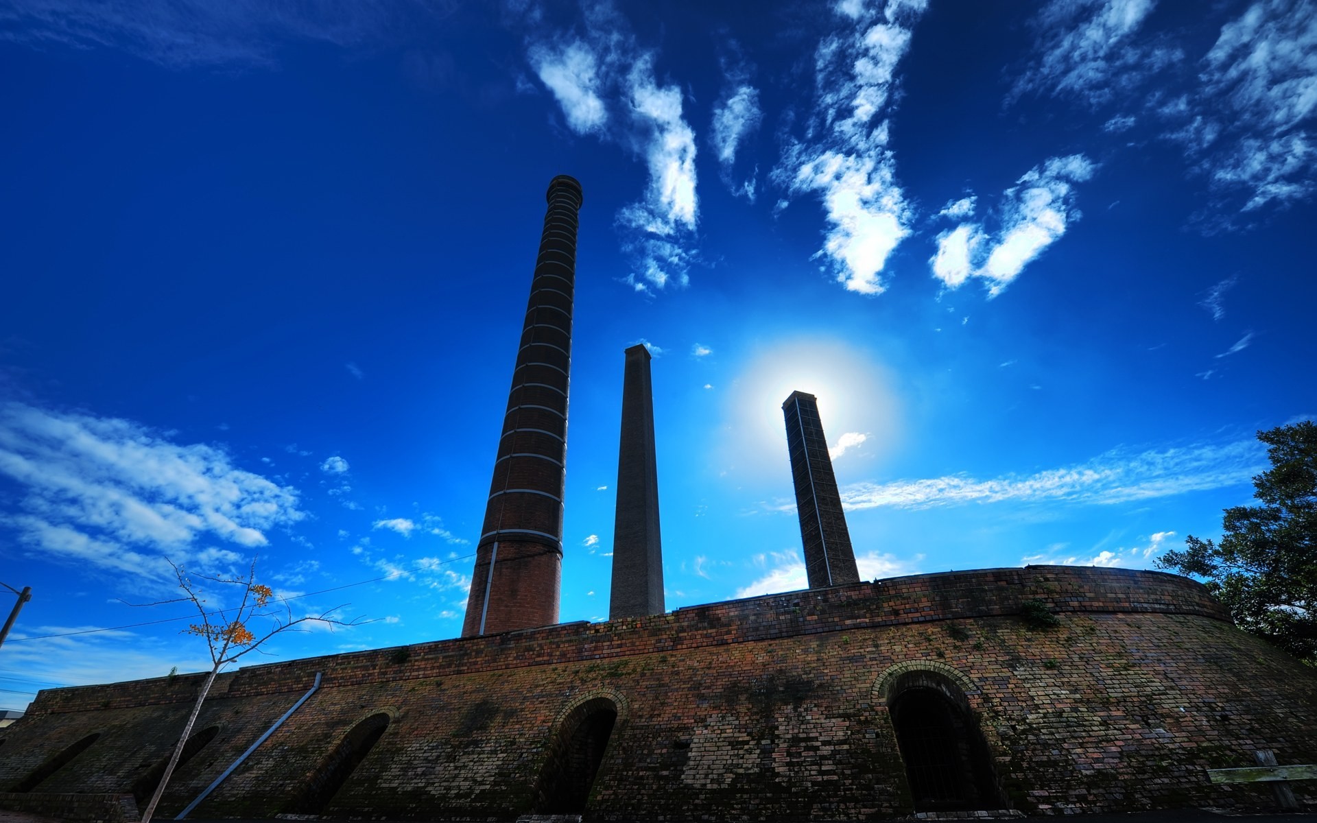 Brick kilns and chimneys in Sydney Park under a blue sky HD Wallpaper