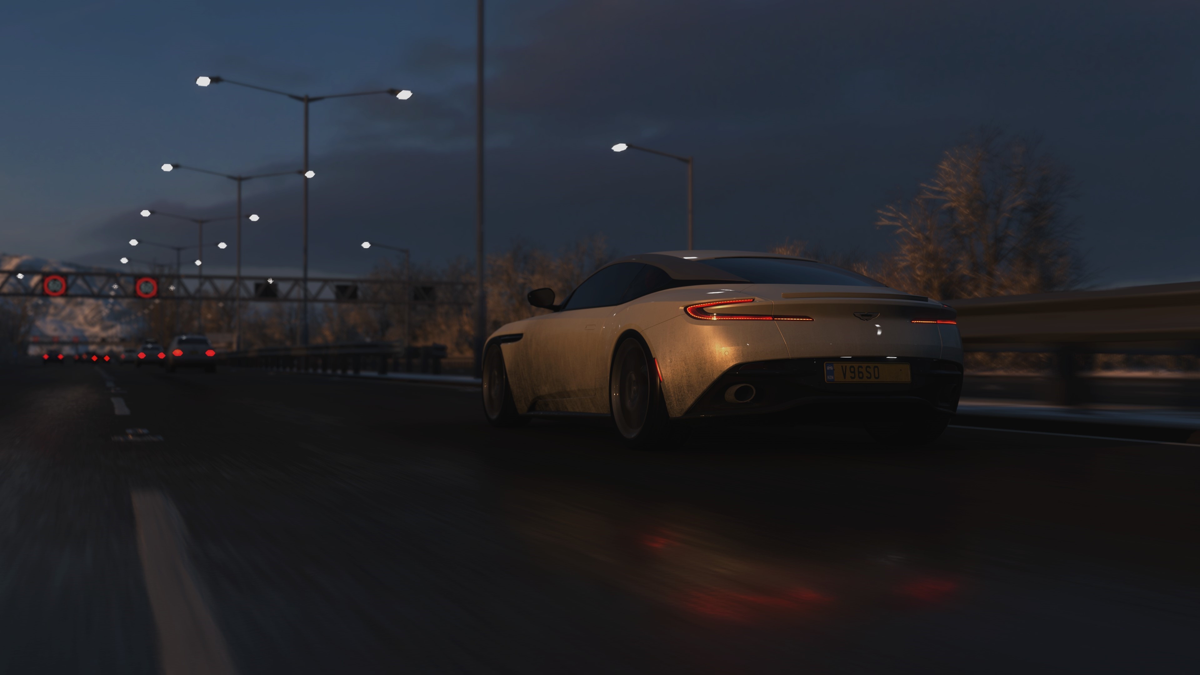 Aston Martin DB11 on a highway at dusk HD Wallpaper