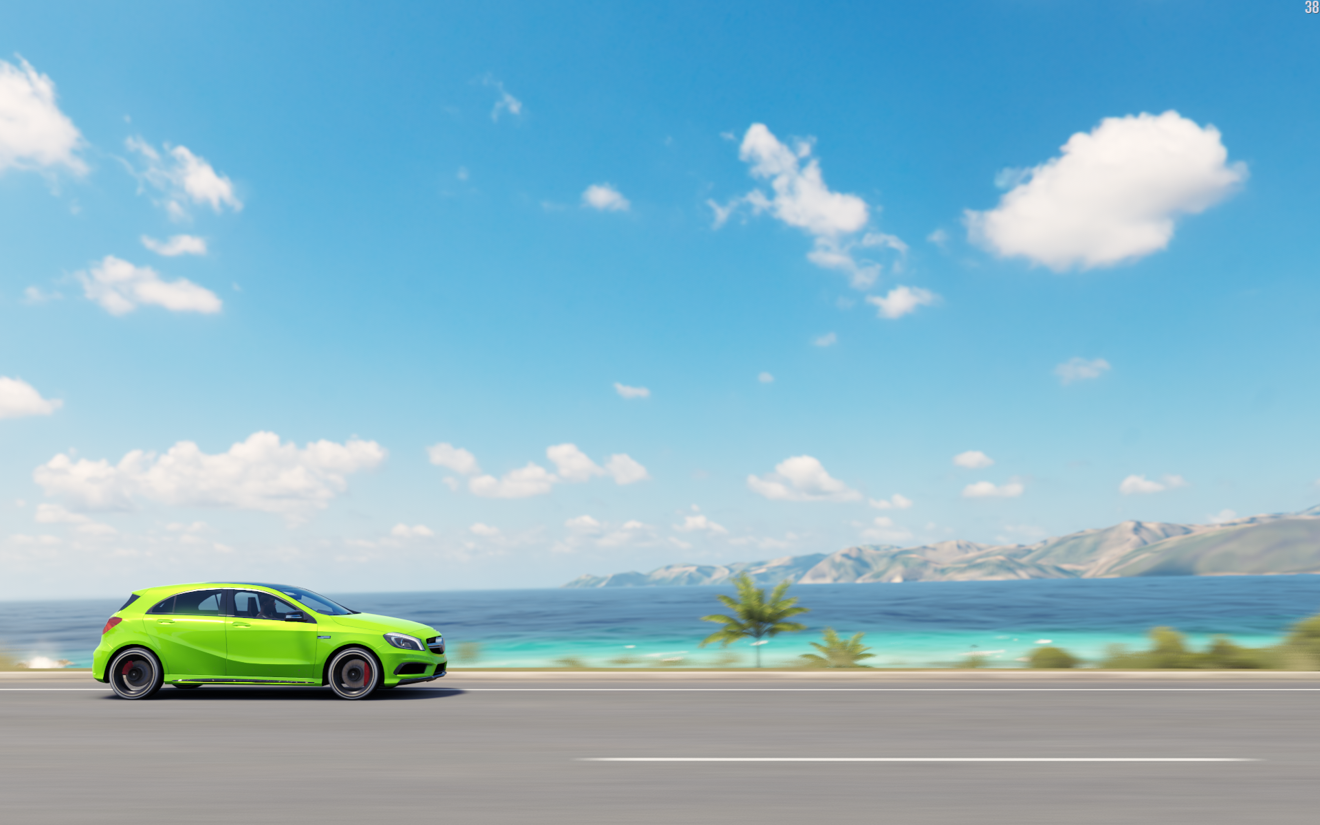 Green car driving on a road by the ocean HD Wallpaper