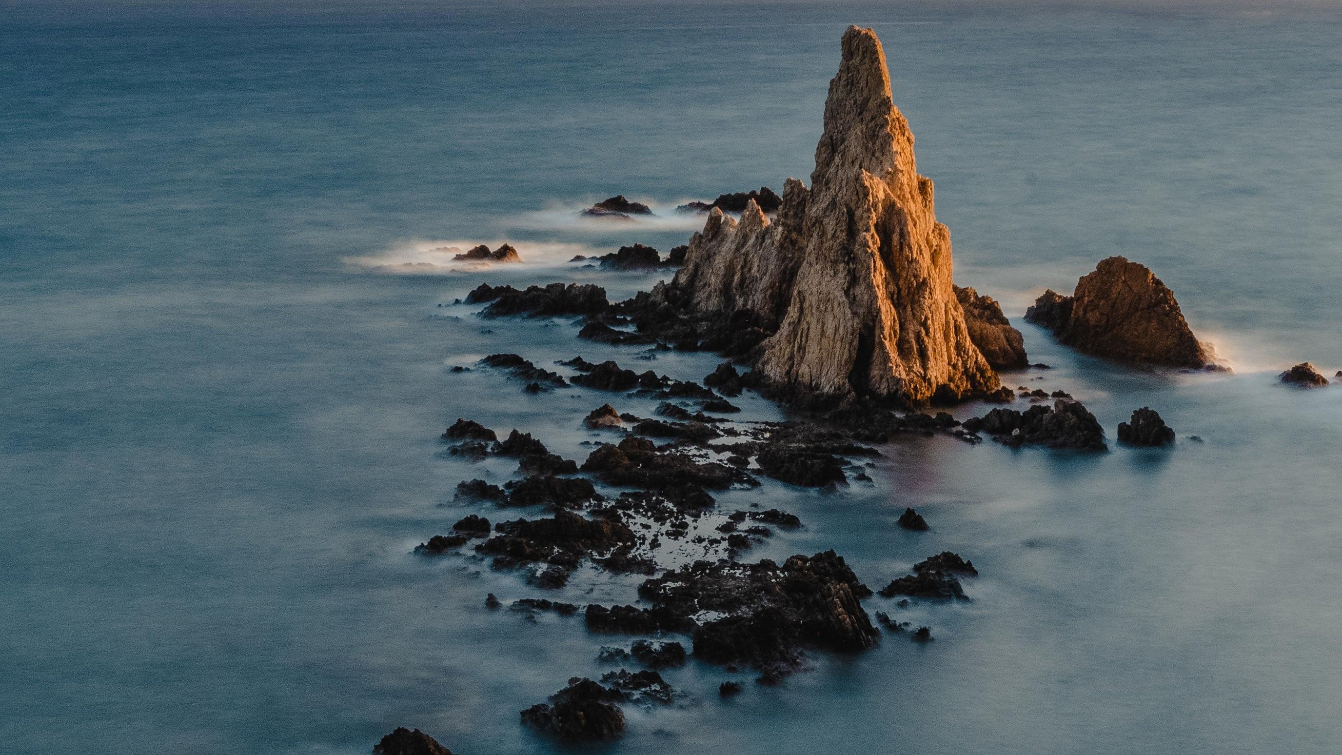 Rocky sea landscape with sharp rock formations HD Wallpaper