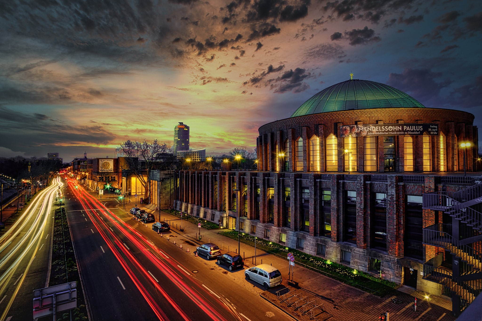 Cityscape at Dusk with Light Trails and Concert Hall HD Wallpaper
