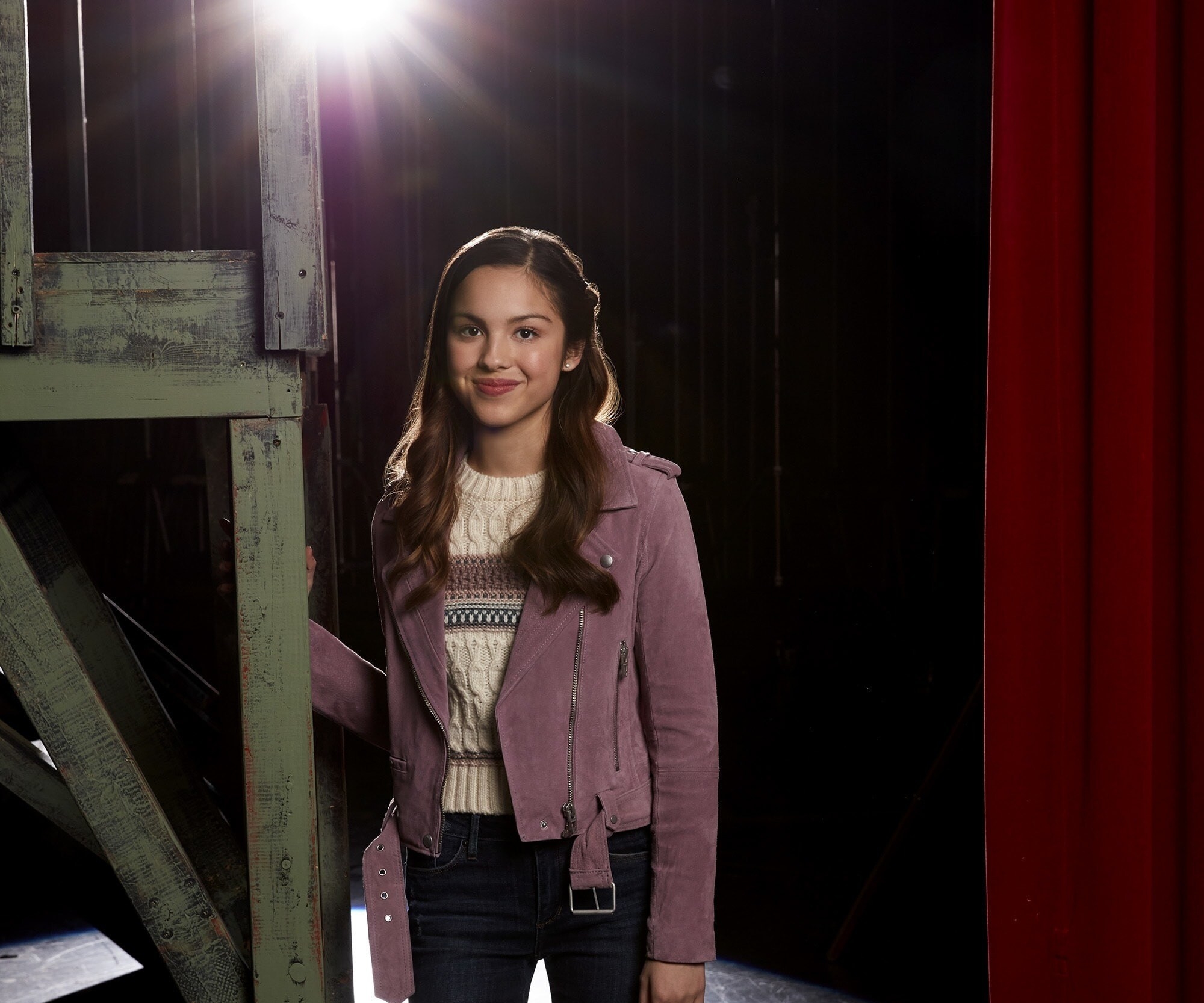 Olivia Rodrigo posing on a stage HD Wallpaper