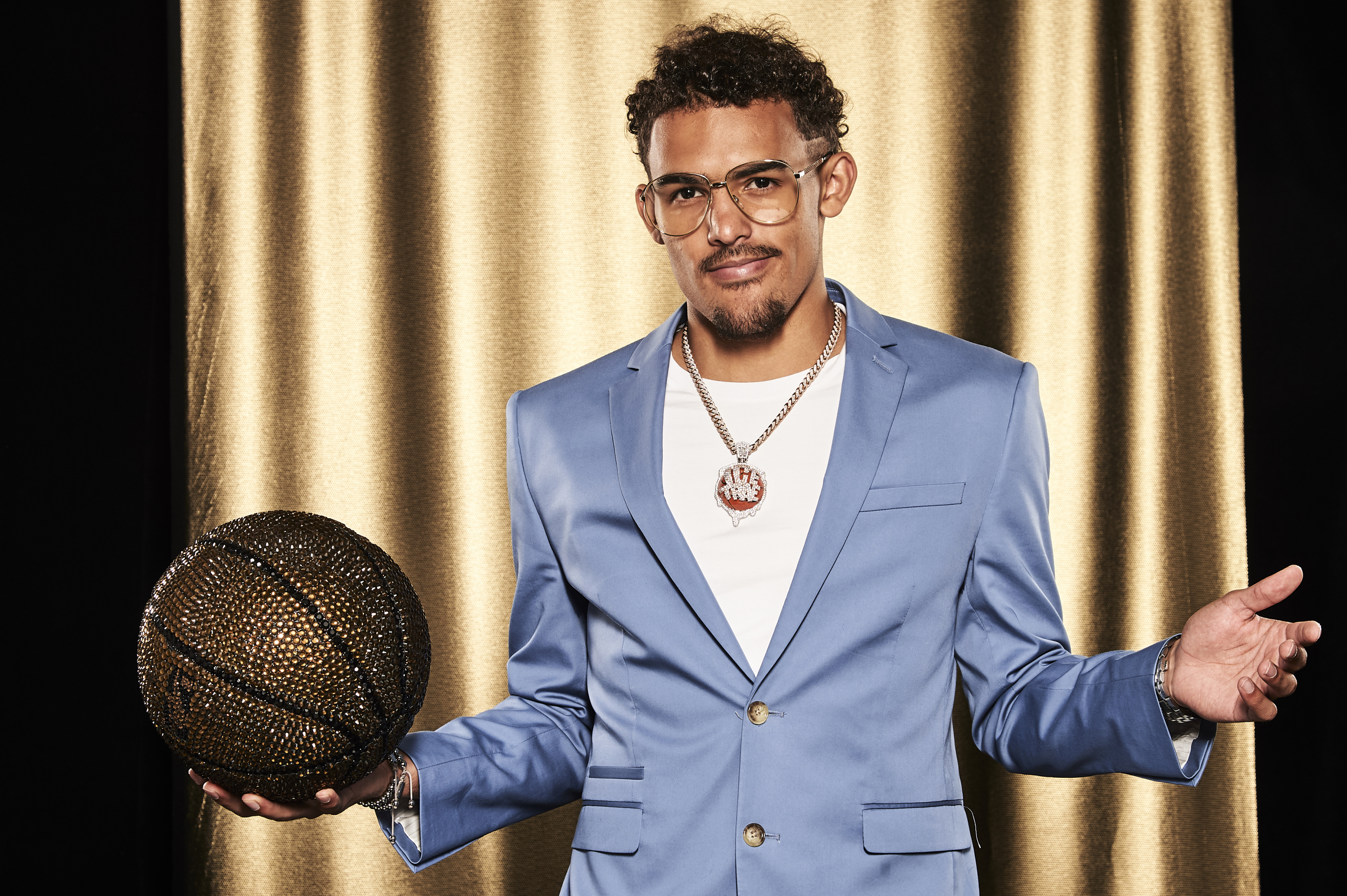 Trae Young in a blue suit holding a jeweled basketball HD Wallpaper