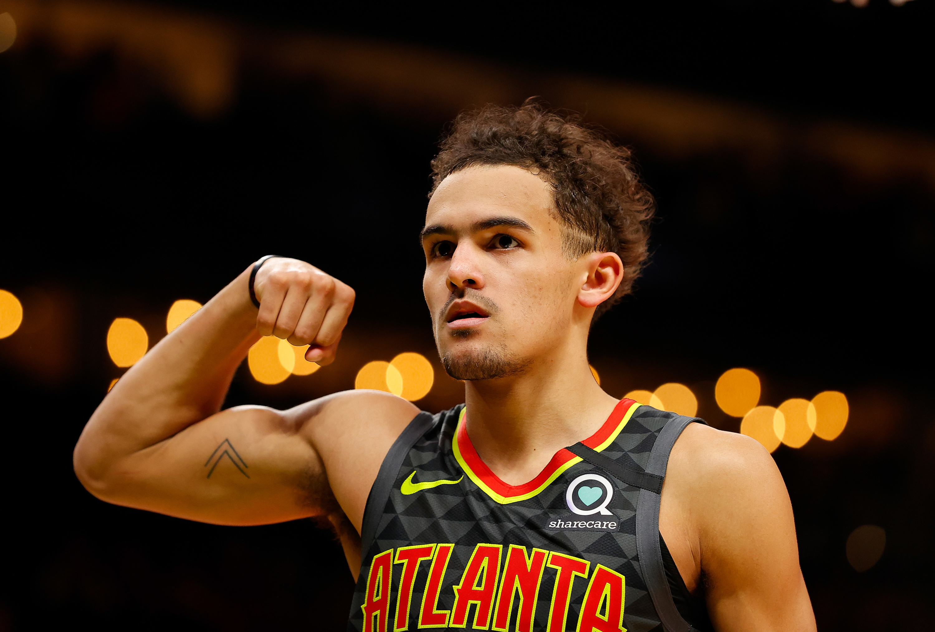 Trae Young flexes his bicep in Atlanta Hawks jersey HD Wallpaper