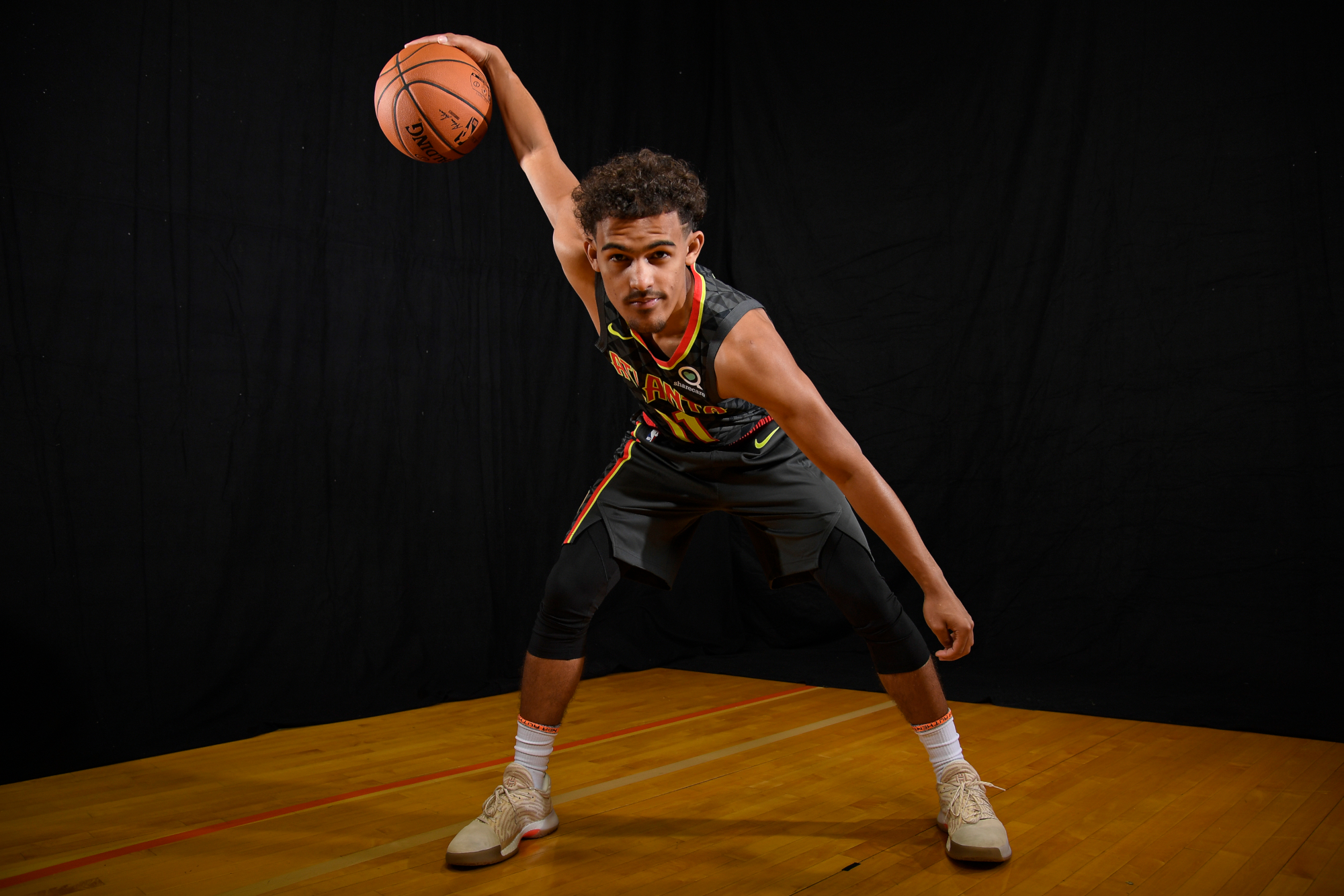 Trae Young of the Atlanta Hawks holding a basketball HD Wallpaper