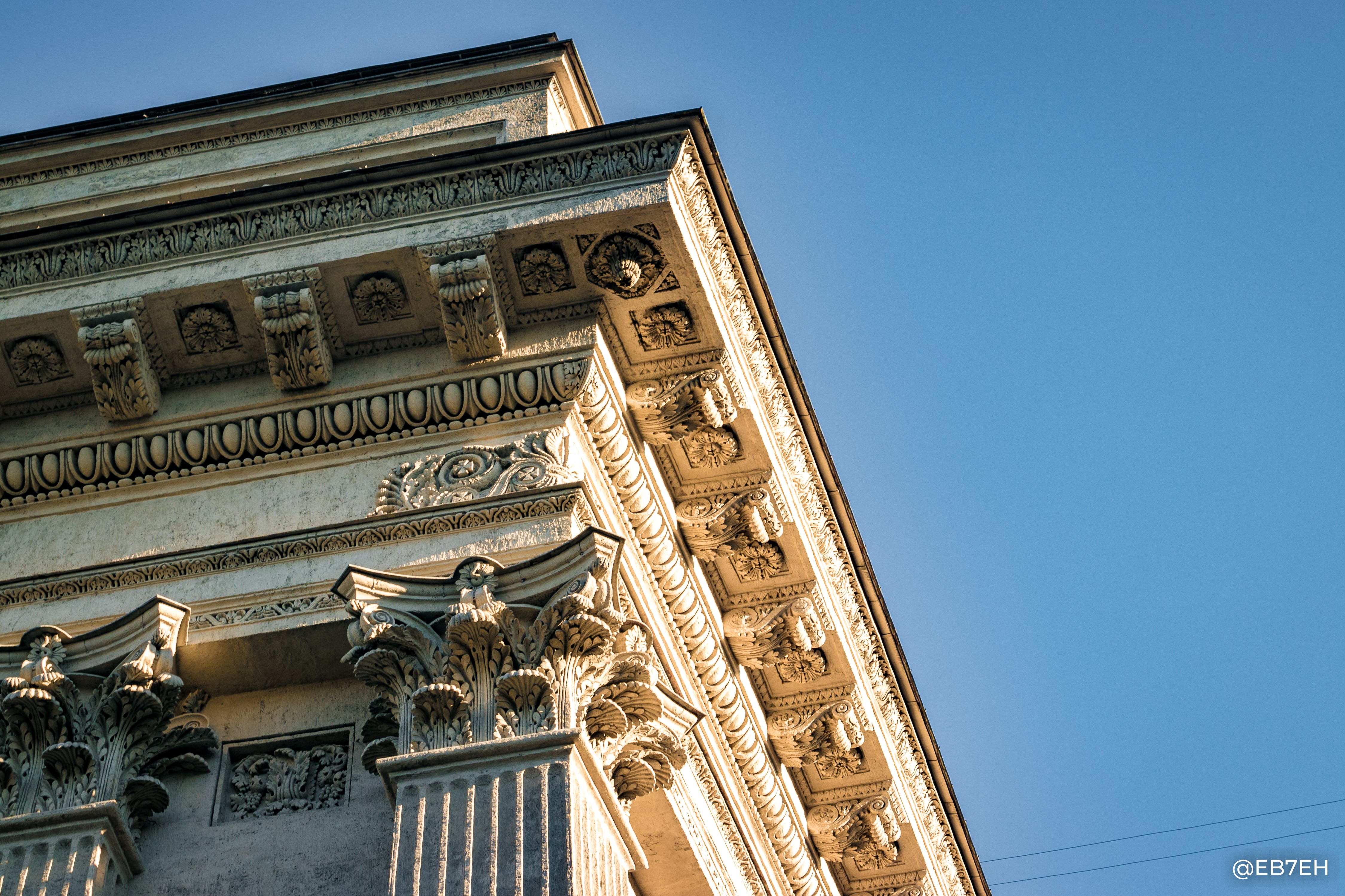 Low-angle view of ornate building facade against blue sky HD Wallpaper