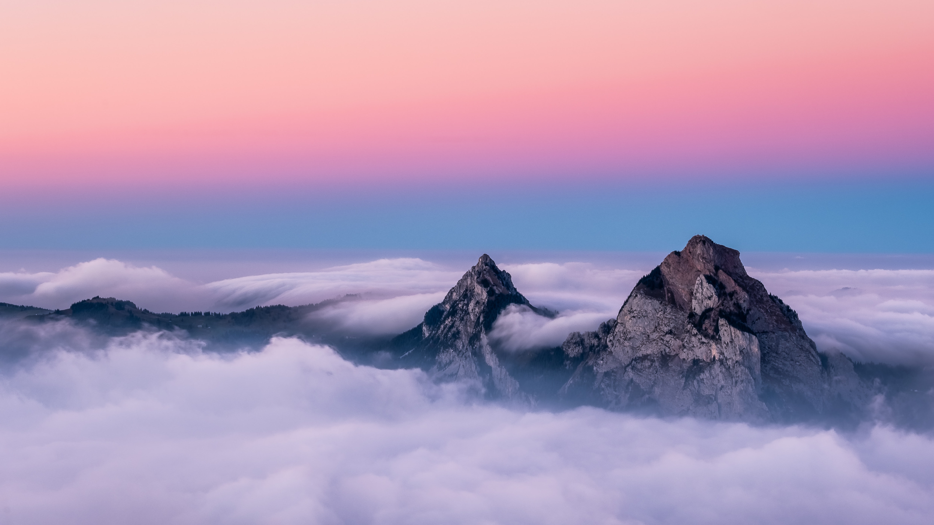 Mountains above clouds at sunset in Switzerland HD Wallpaper