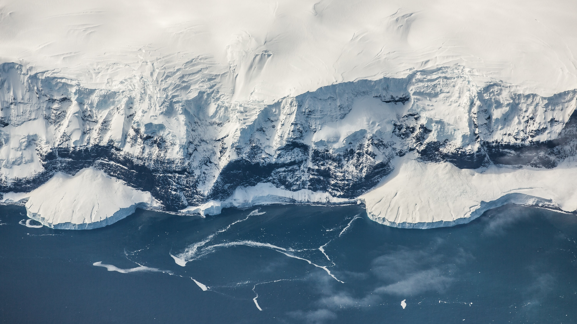Aerial view of Antarctic ice cliffs and ocean HD Wallpaper