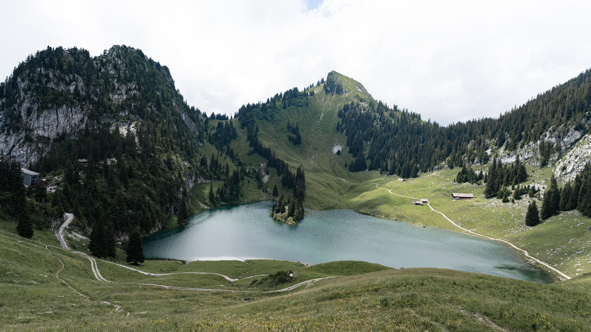 Lake and mountains in Switzerland with houses and roads HD Wallpaper