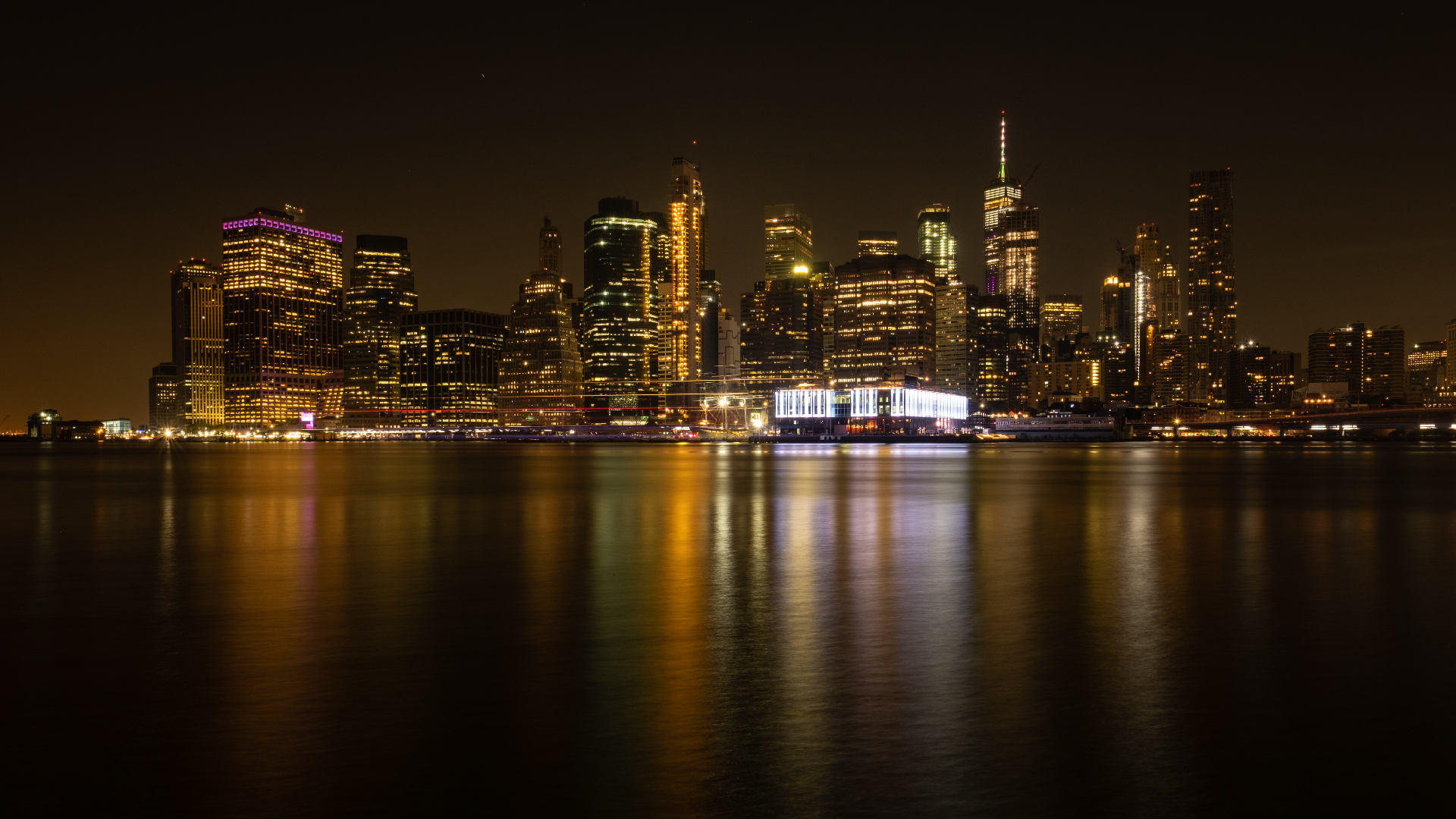 New York City skyline at night with water reflection HD Wallpaper