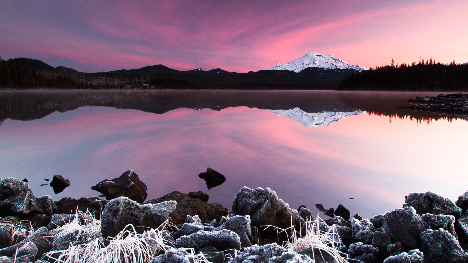 Snowy mountain reflected in a lake at sunset HD Wallpaper