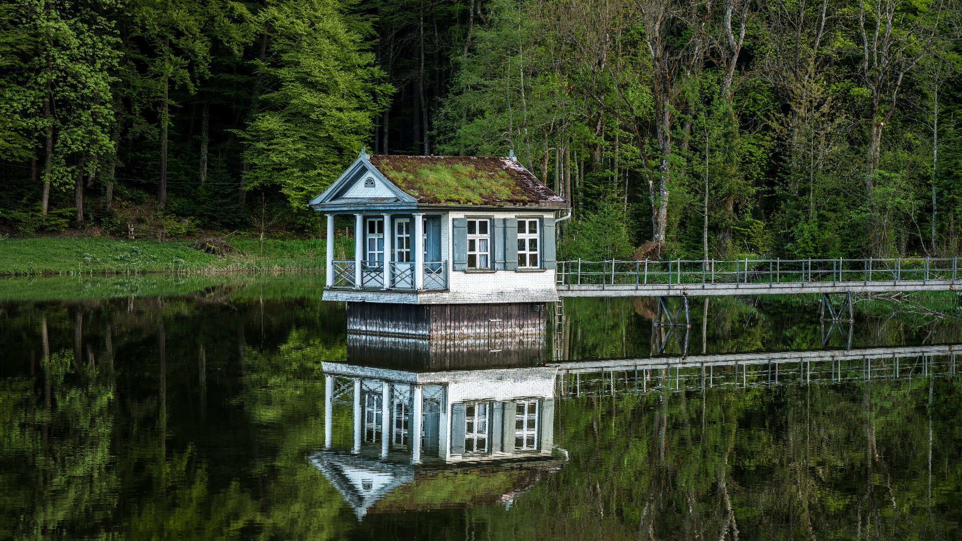 House on a lake with forest and bridge in Switzerland HD Wallpaper