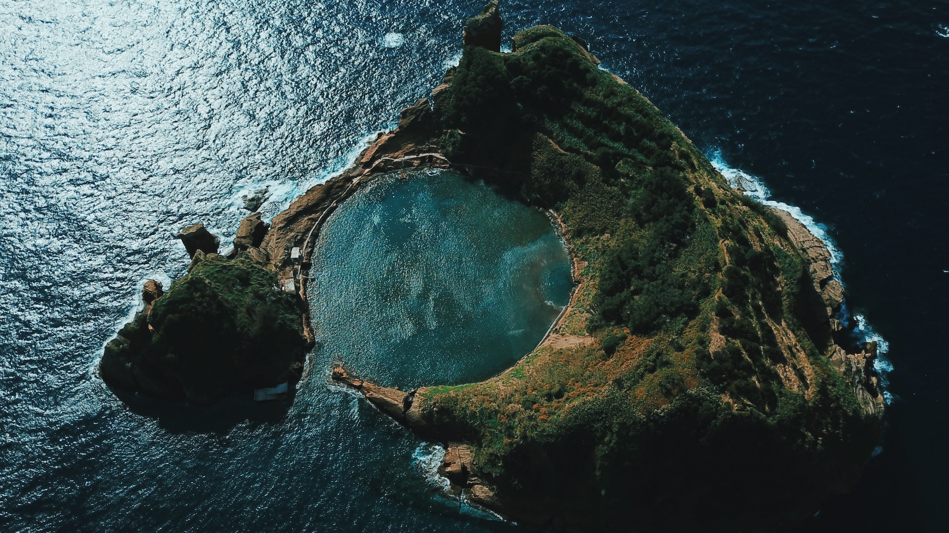 Aerial view of a volcanic island with a crater lake in the Azores HD Wallpaper