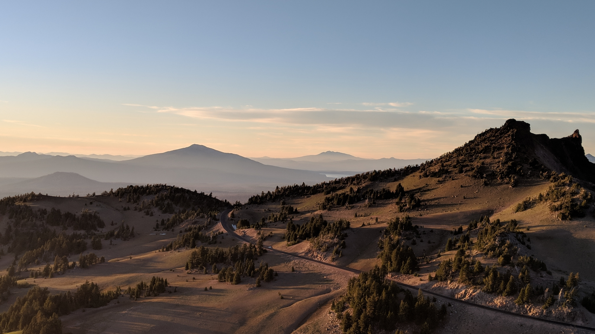 Mountain landscape with road and trees at sunset HD Wallpaper