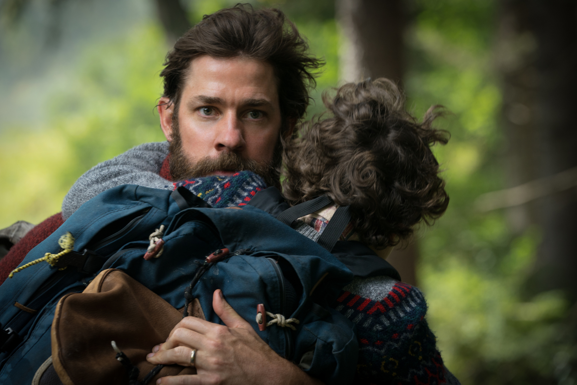 Lee Abbott holding a child in A Quiet Place HD Wallpaper
