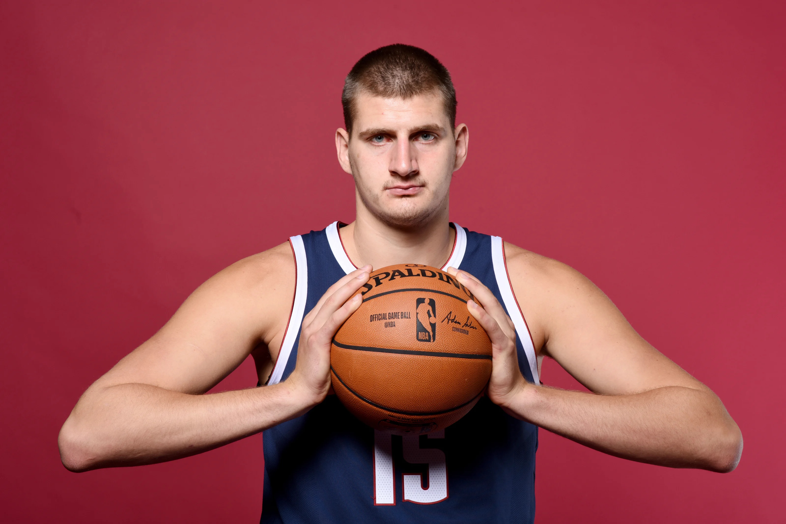 Nikola Jokic holding a Spalding NBA basketball HD Wallpaper