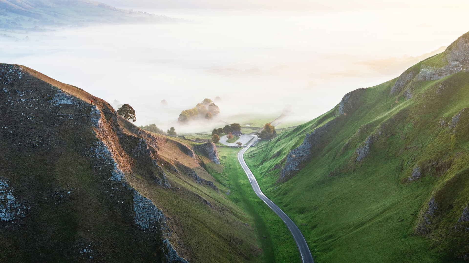 Road through a misty valley in the UK at sunrise HD Wallpaper
