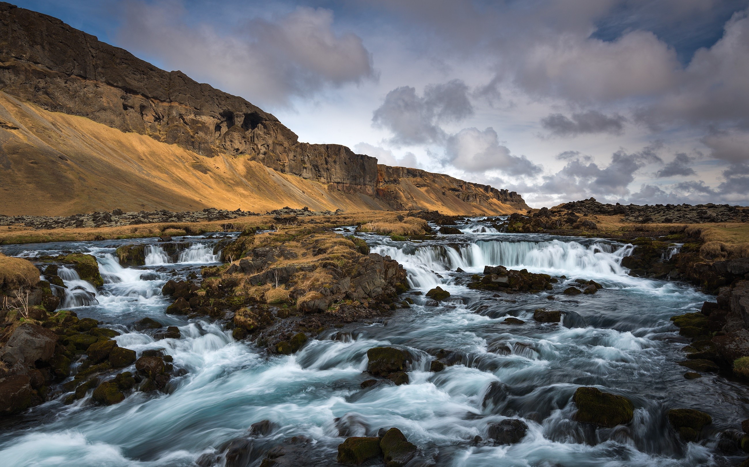 River flowing through rocky landscape in Iceland HD Wallpaper