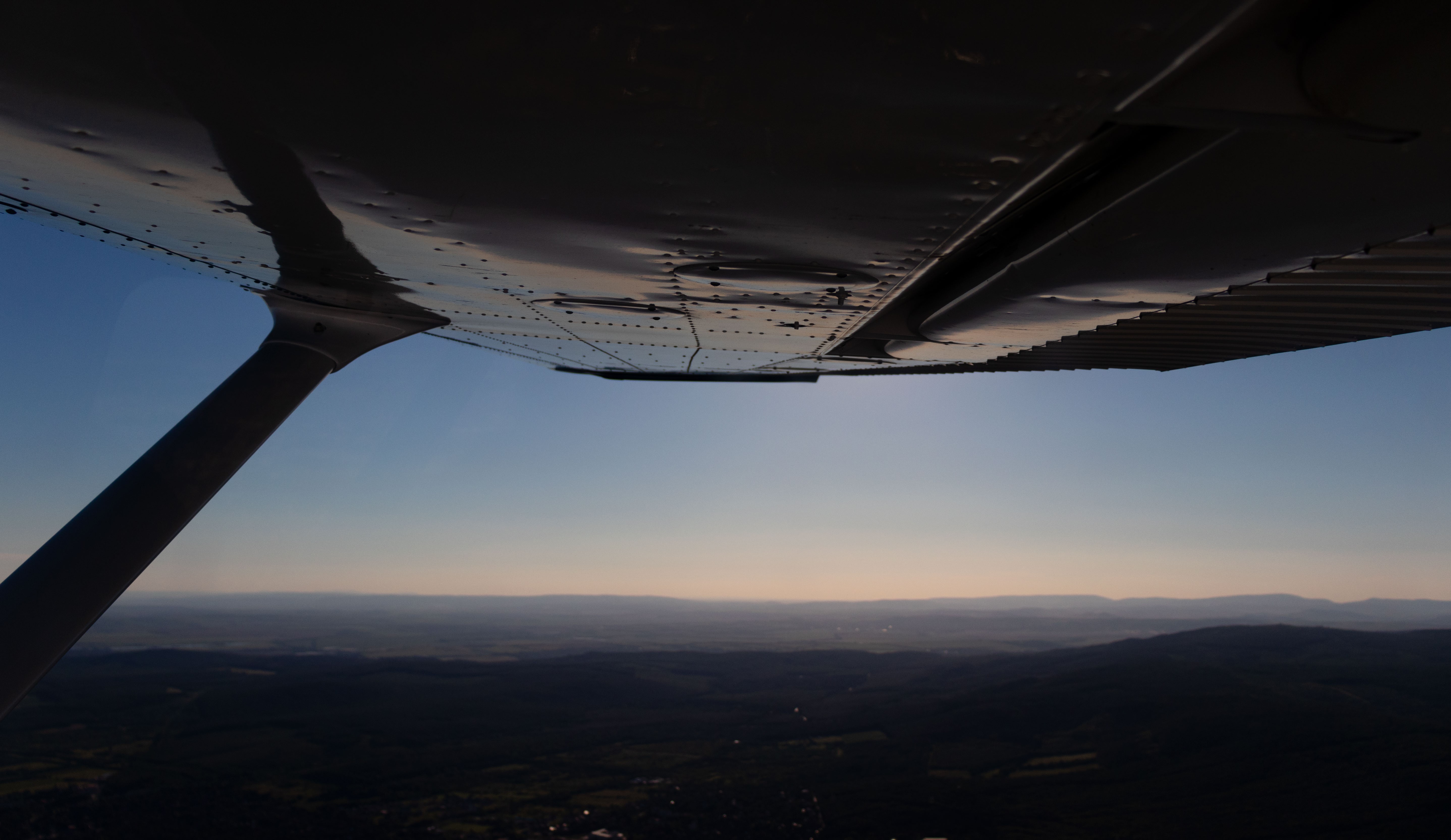 View from a Cessna aircraft over hills HD Wallpaper