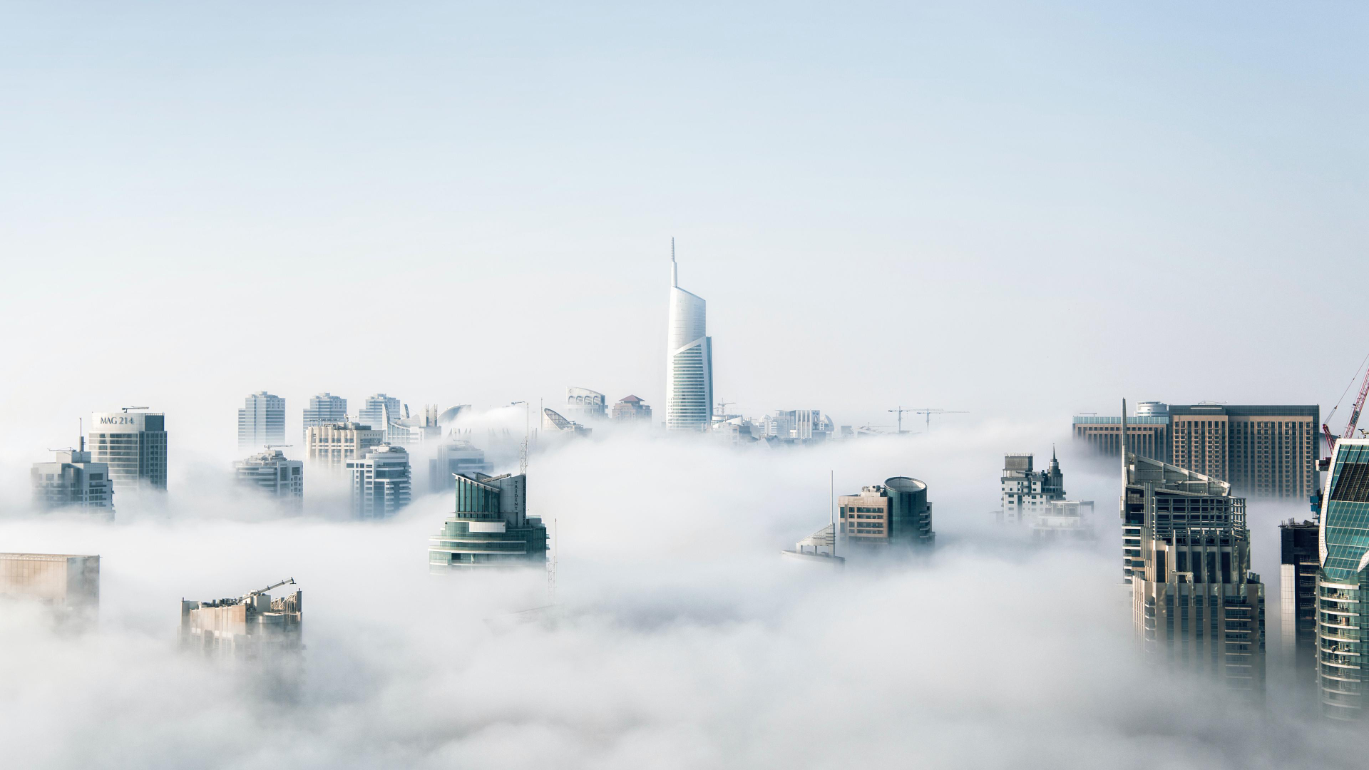 City skyscrapers emerging from clouds HD Wallpaper
