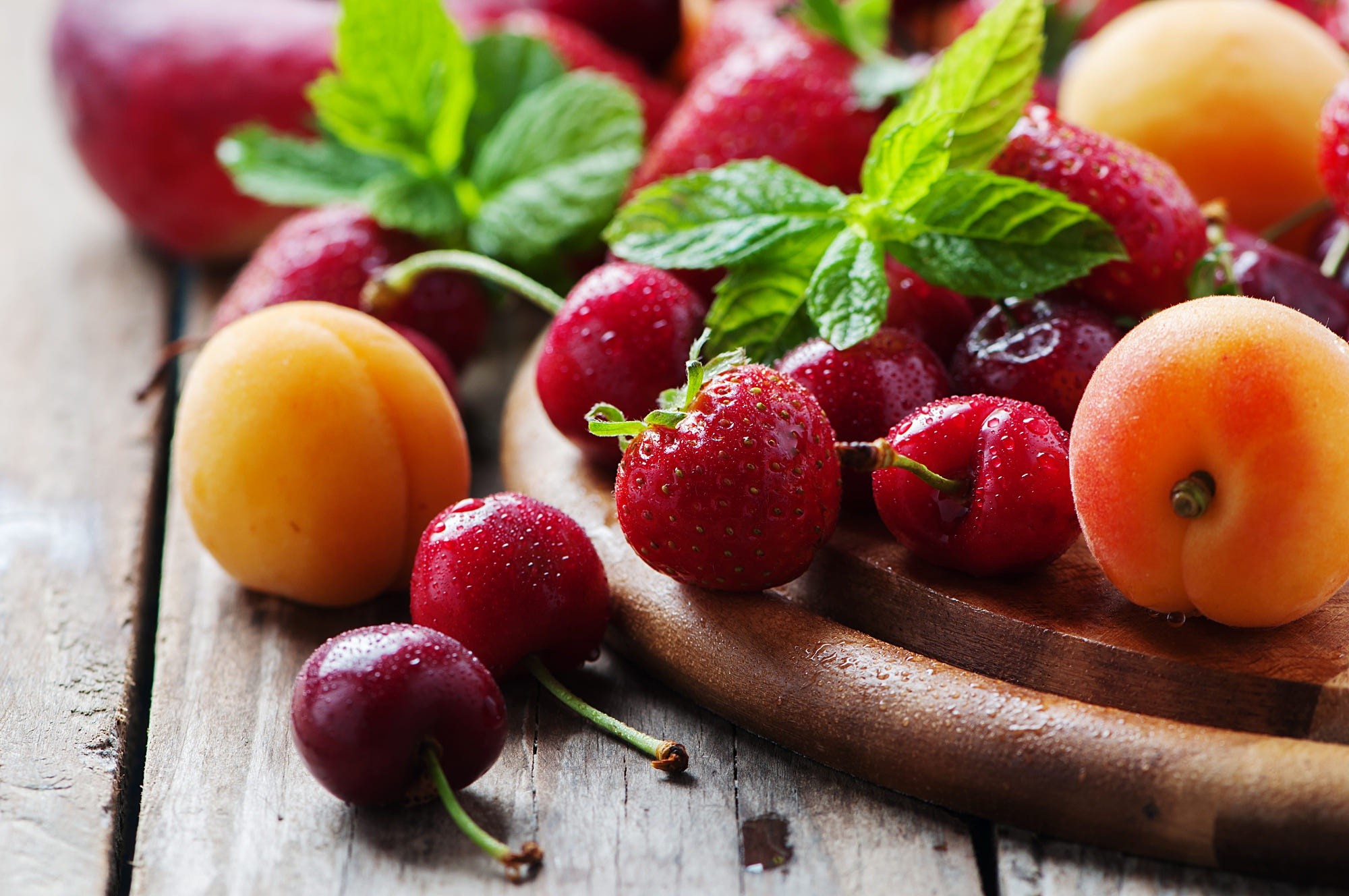 Assortment of fresh fruits including strawberries, cherries, and apricots HD Wallpaper