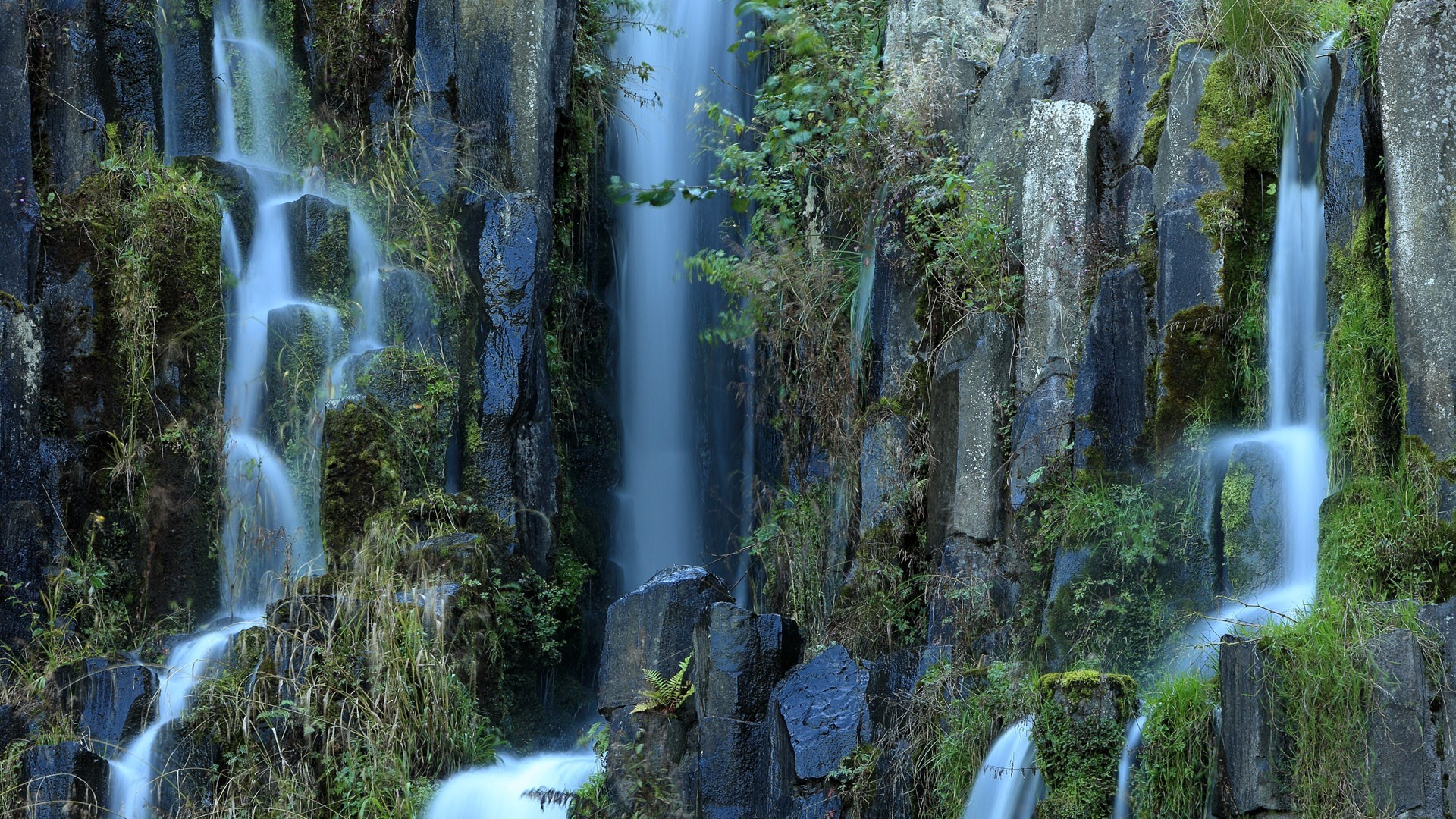 Waterfall cascading over basalt columns in Germany HD Wallpaper
