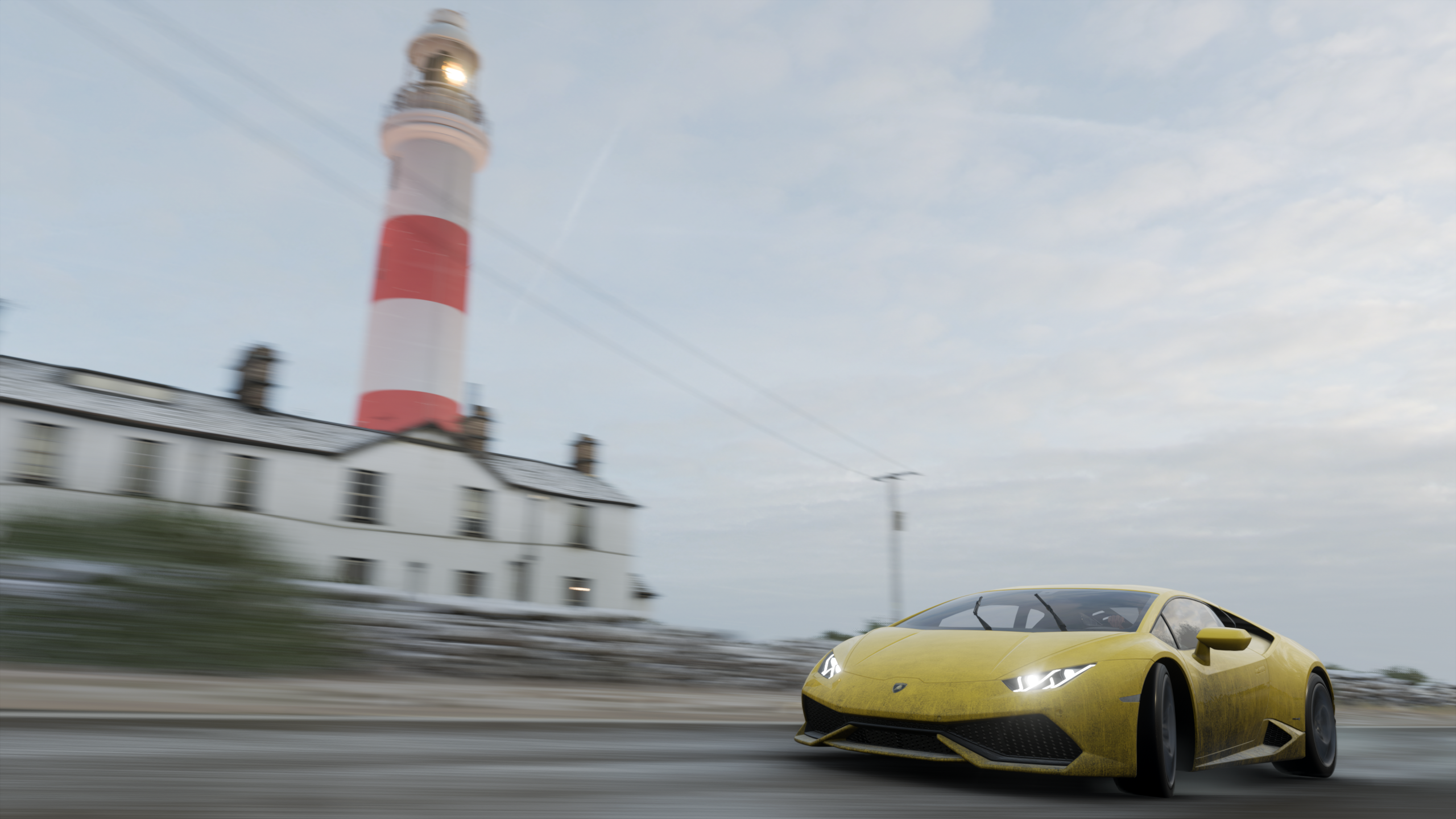 Yellow Lamborghini driving past a lighthouse in Forza Horizon 4 HD Wallpaper