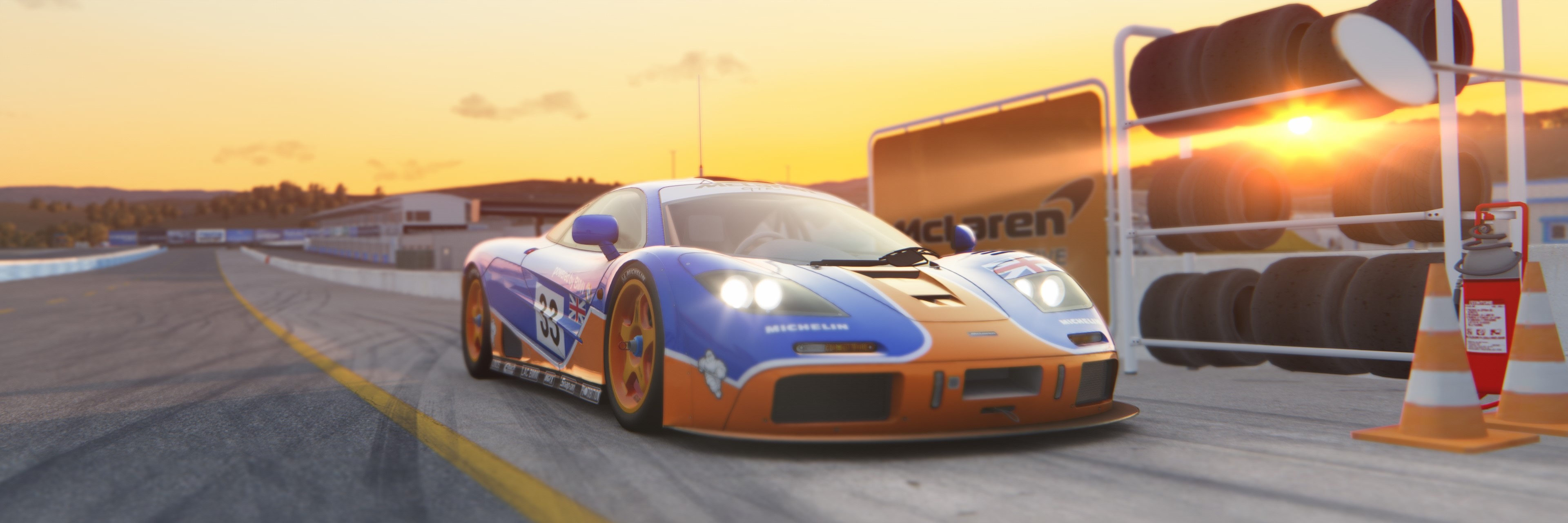McLaren F1 GTR race car on track at sunset HD Wallpaper