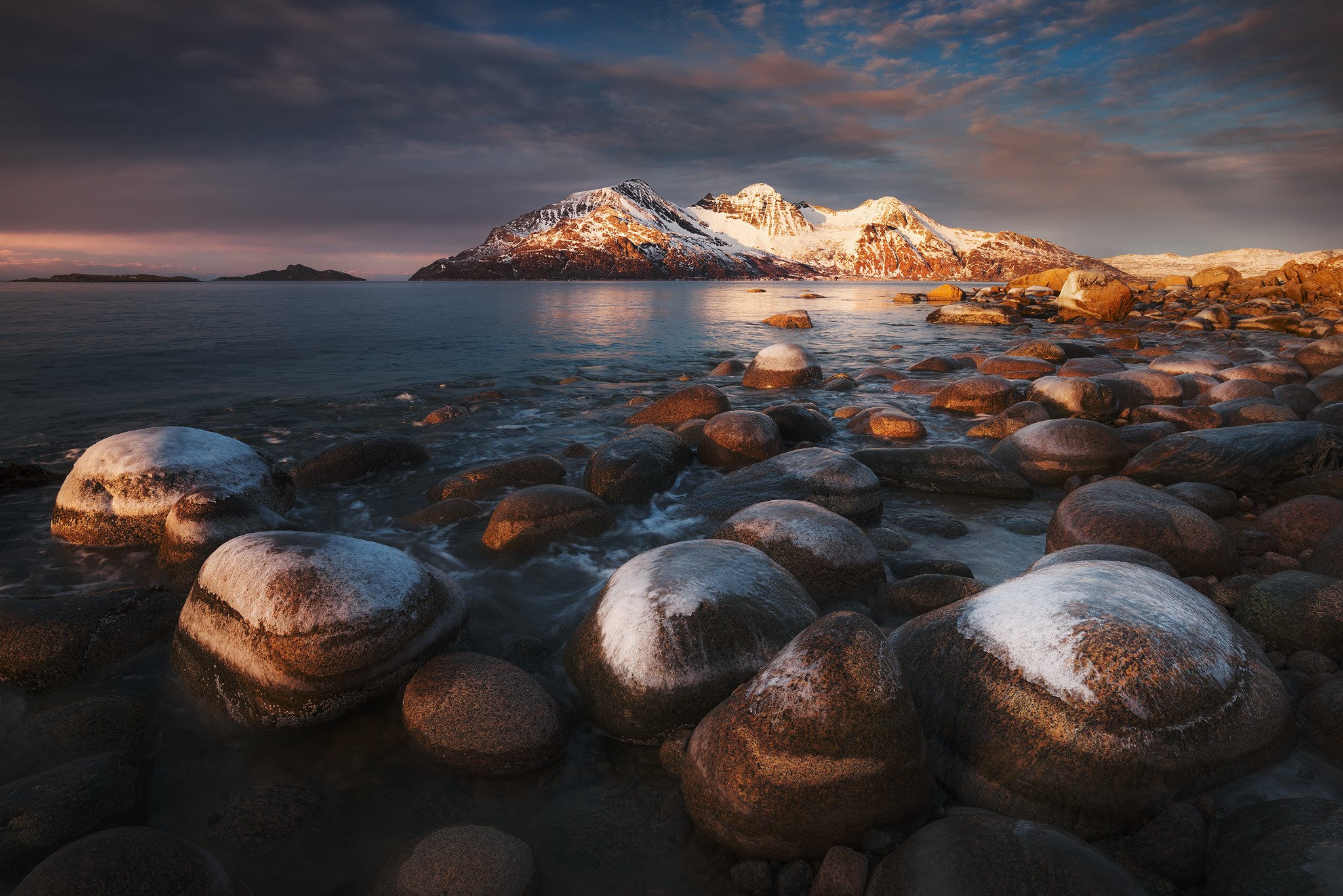 Snowy mountains and rocky shore at sunset HD Wallpaper