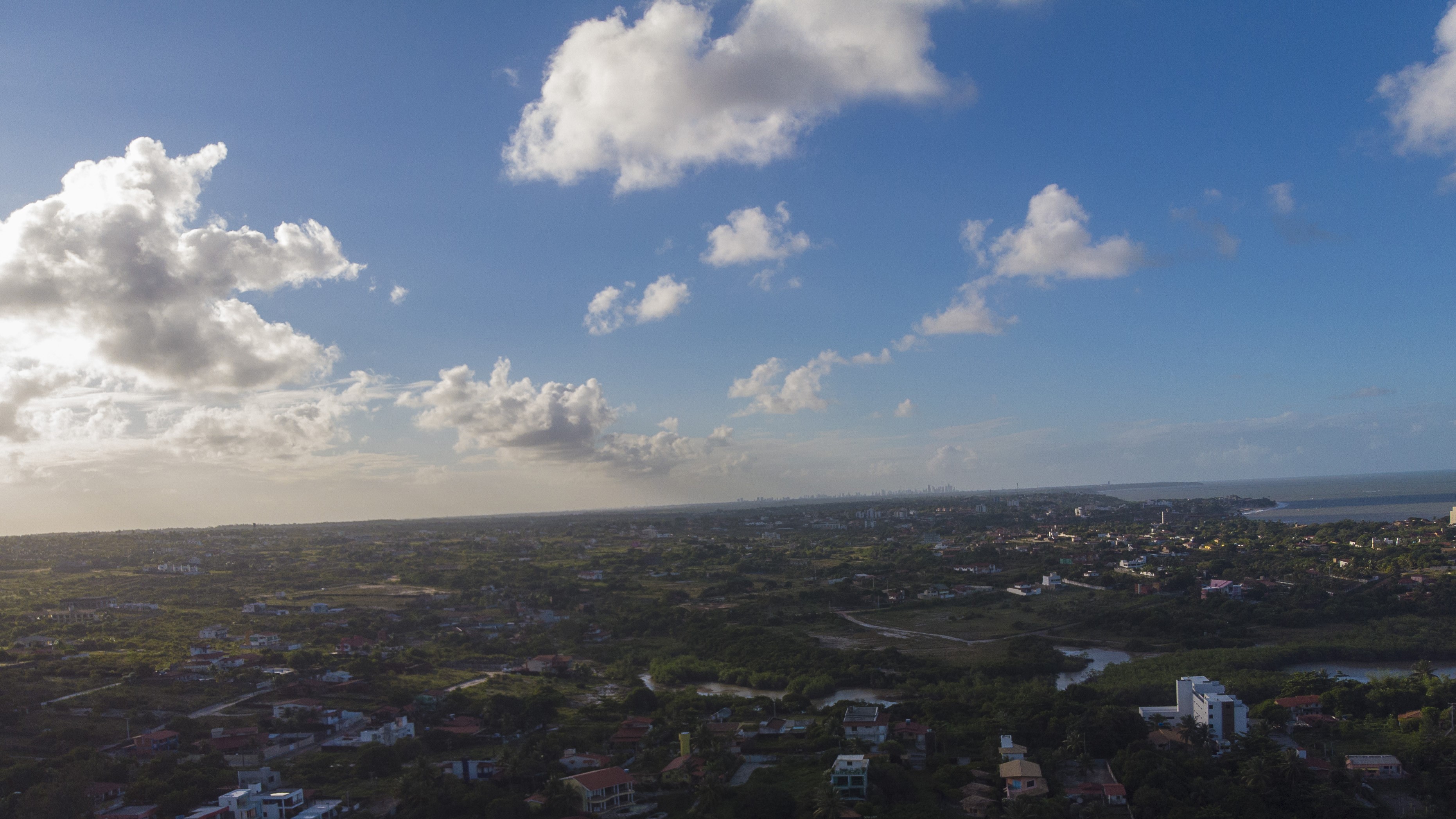Aerial view of a coastal city in Brazil with clouds HD Wallpaper