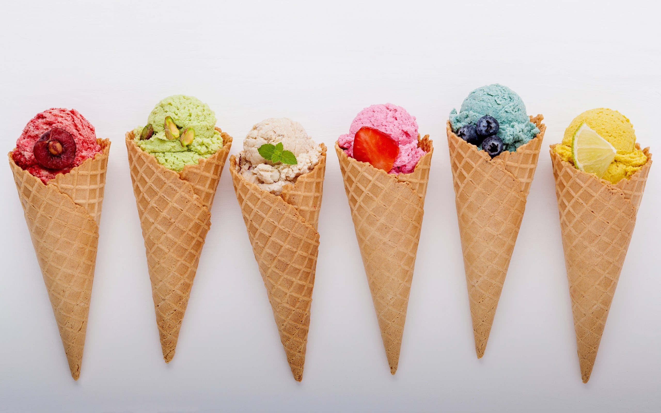 Six ice cream cones with various toppings on a white background HD Wallpaper
