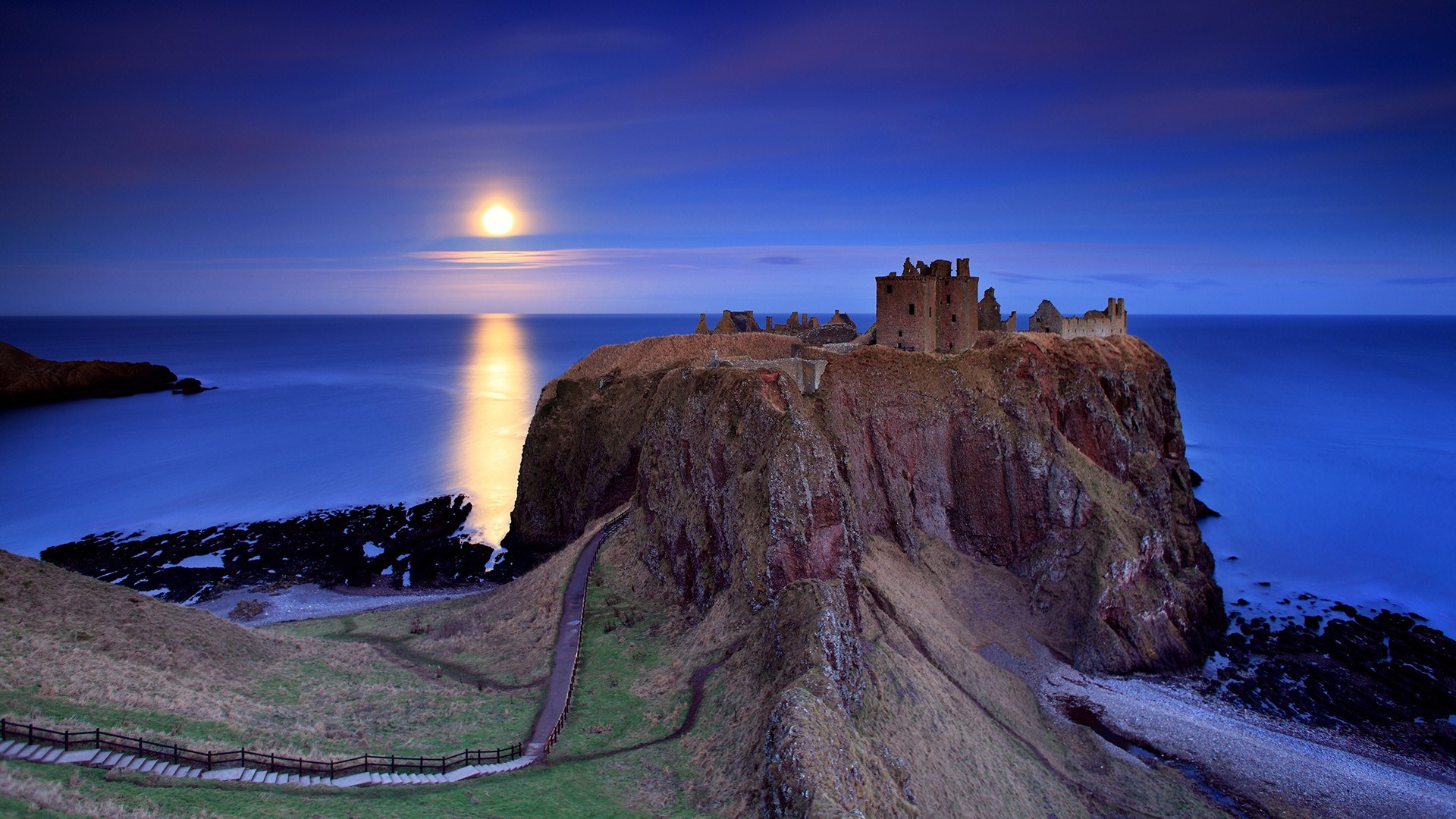 Castle ruins on a cliff overlooking the sea at moonlight HD Wallpaper