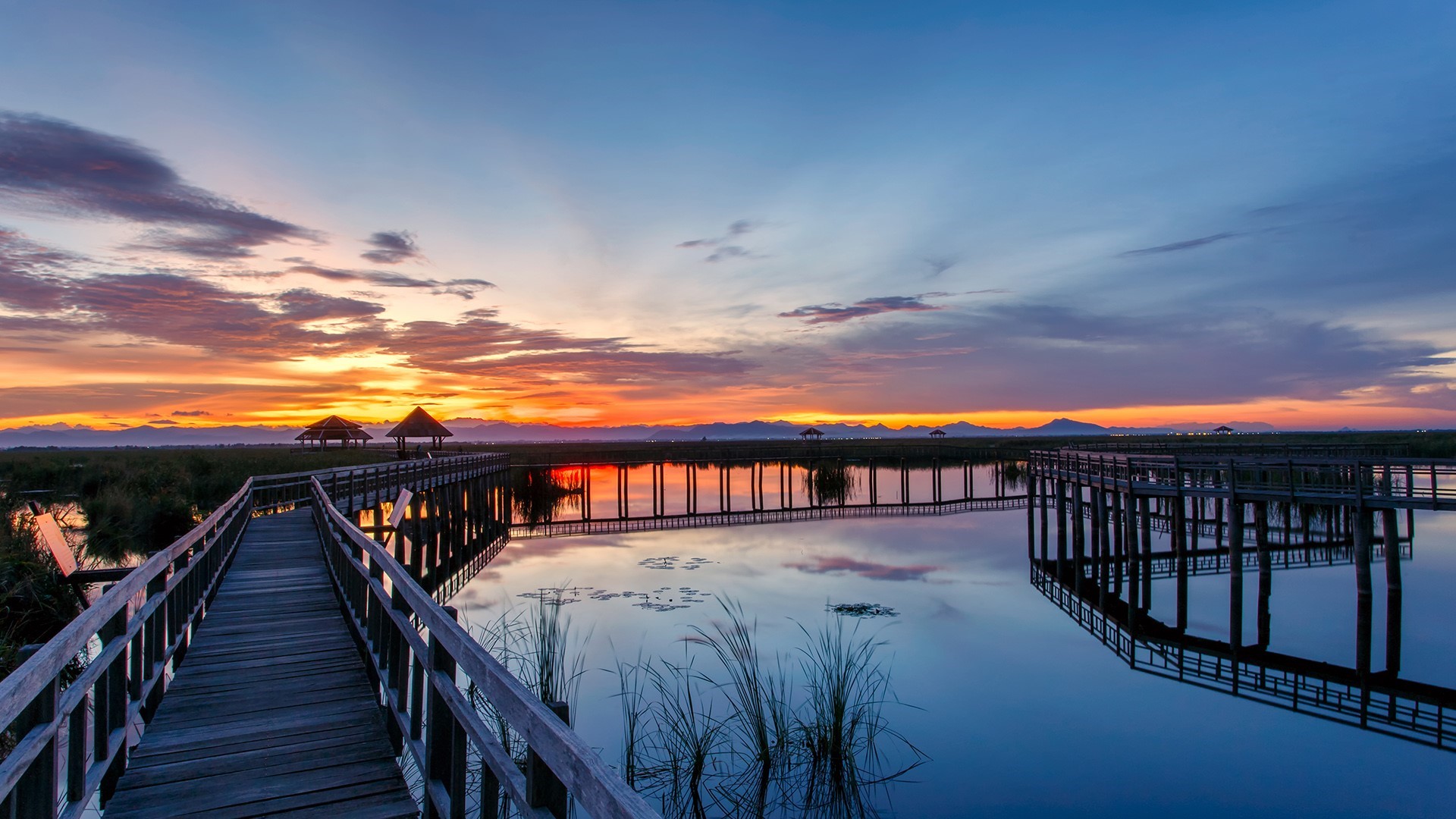 Wooden walkway over water at dawn in Thailand HD Wallpaper