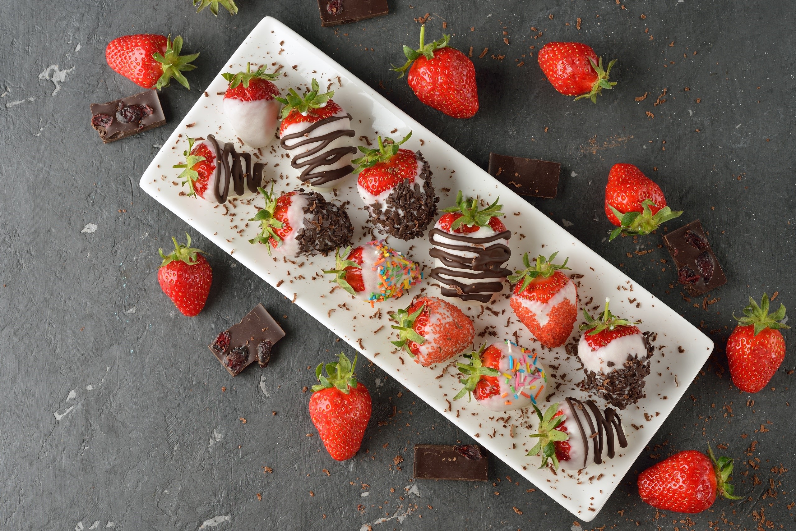 Chocolate-dipped strawberries on a white platter HD Wallpaper