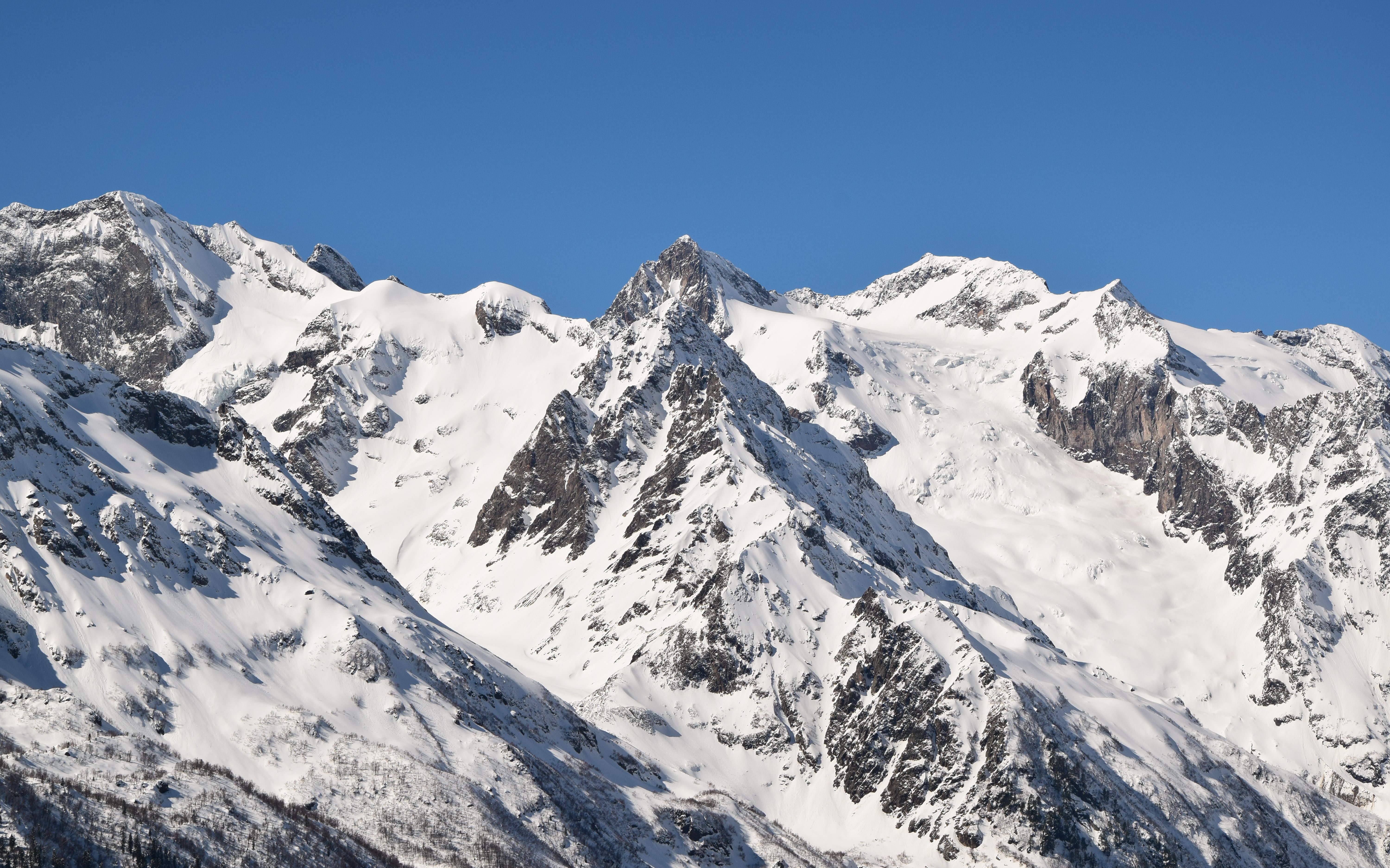 4K snow-covered mountains under clear blue sky HD Wallpaper