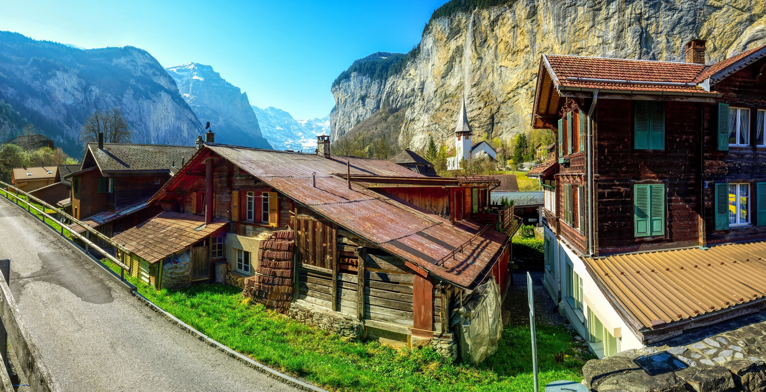 Traditional houses in Lauterbrunnen, Switzerland with mountains HD Wallpaper