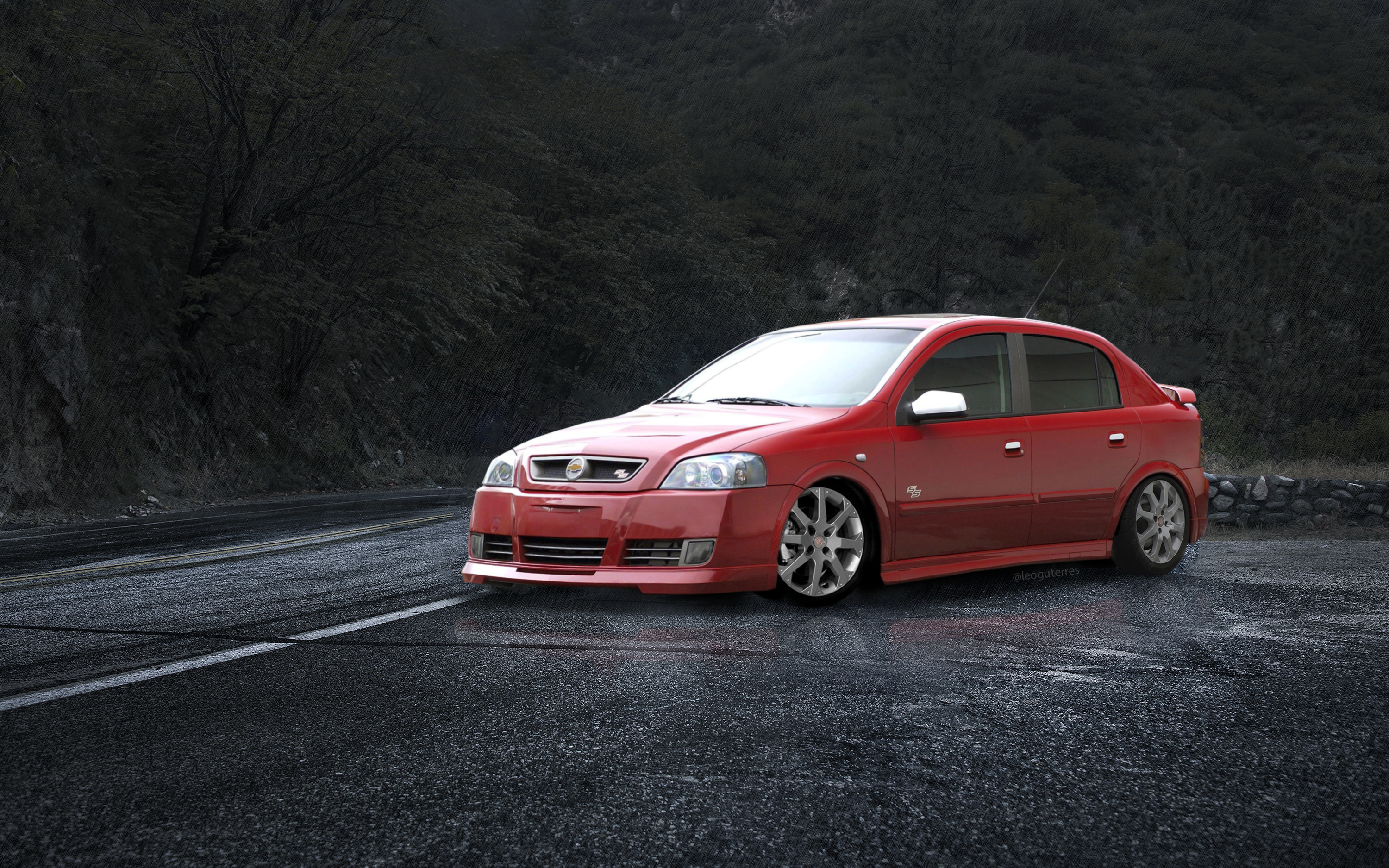 Red Opel Astra on a Wet Road HD Wallpaper