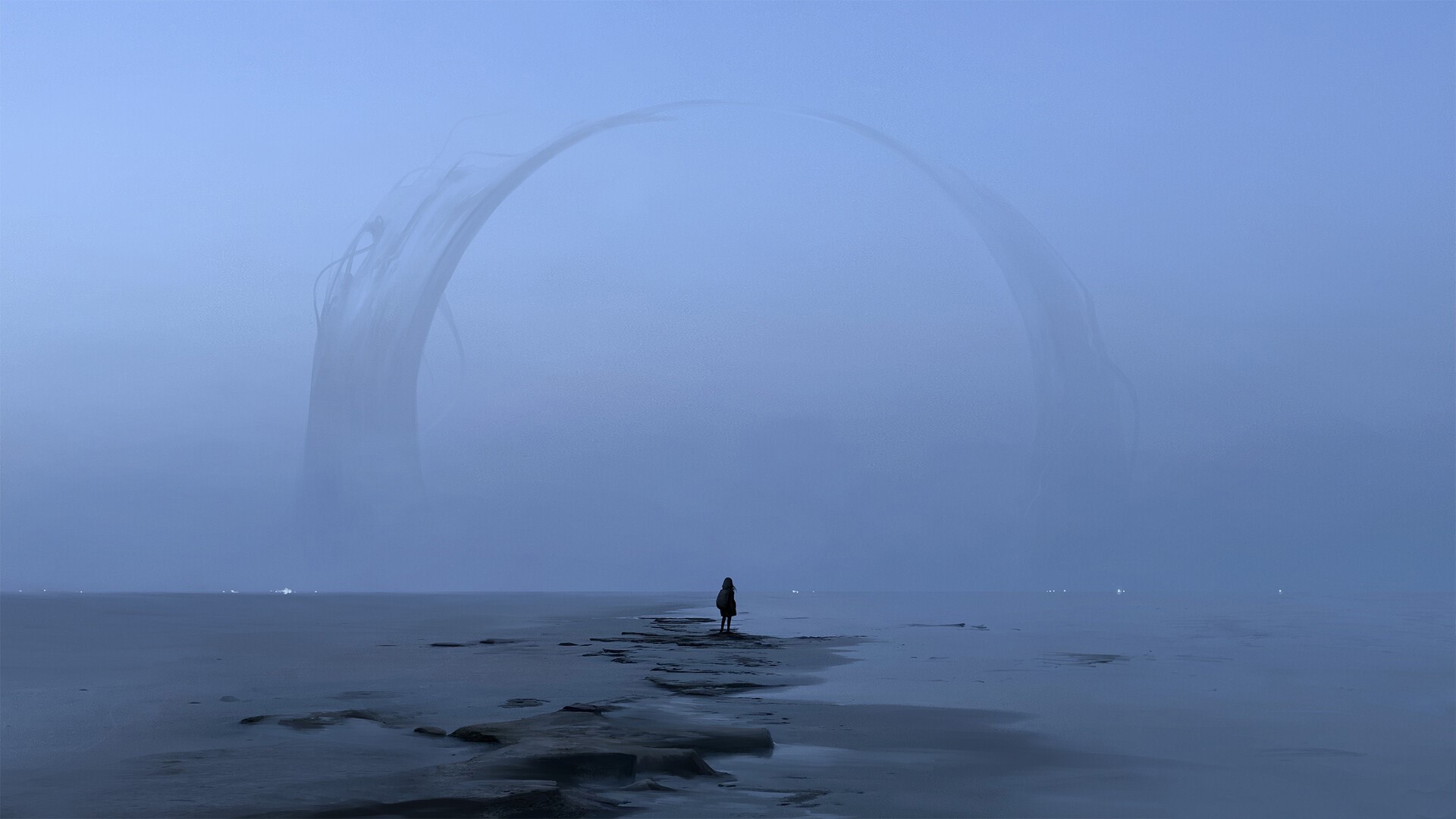 Figure standing on a beach with a large arch in the fog HD Wallpaper