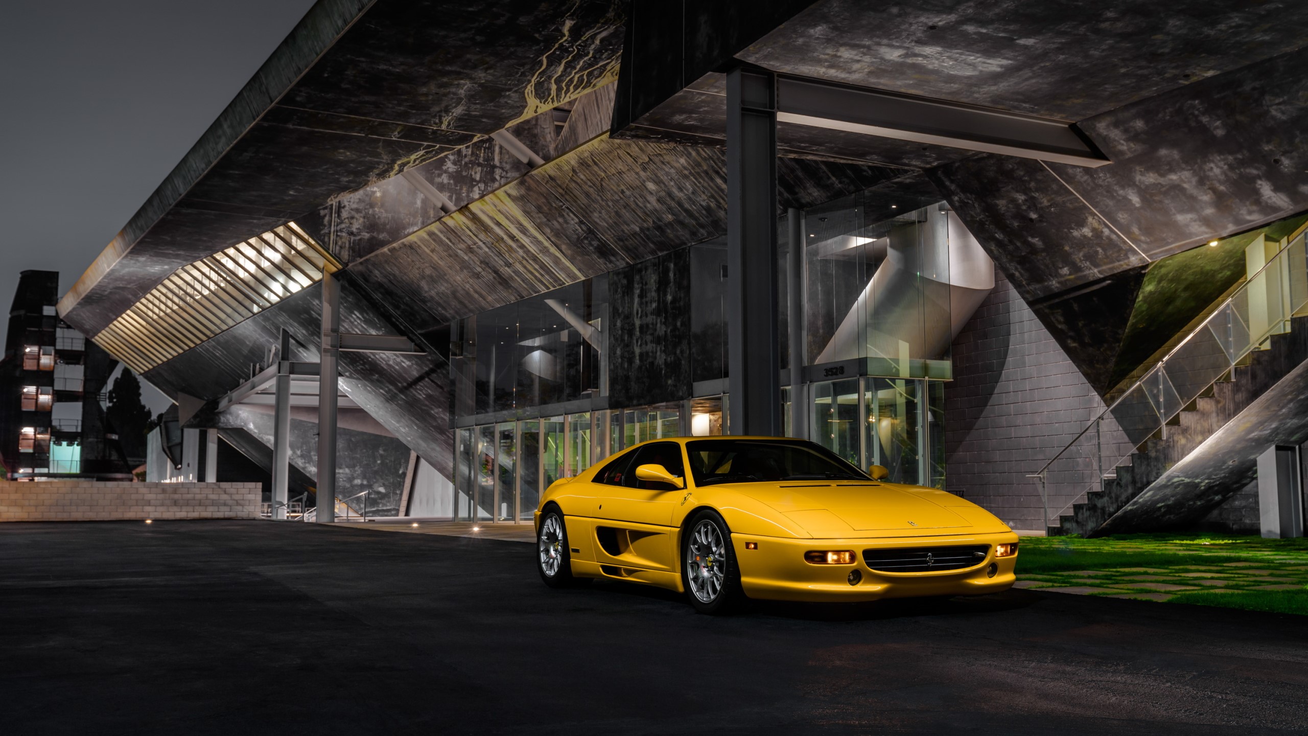 Yellow Ferrari F355 parked at modern building at night HD Wallpaper