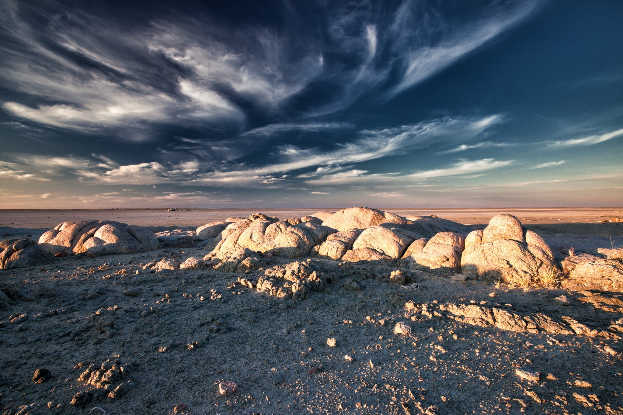 Rocky landscape under a dramatic sky in Botswana HD Wallpaper