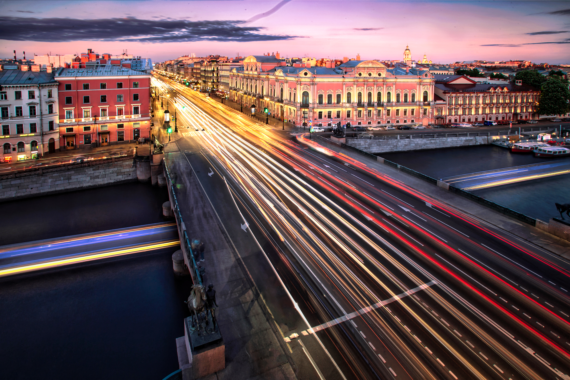 Cityscape at night with light trails from cars HD Wallpaper
