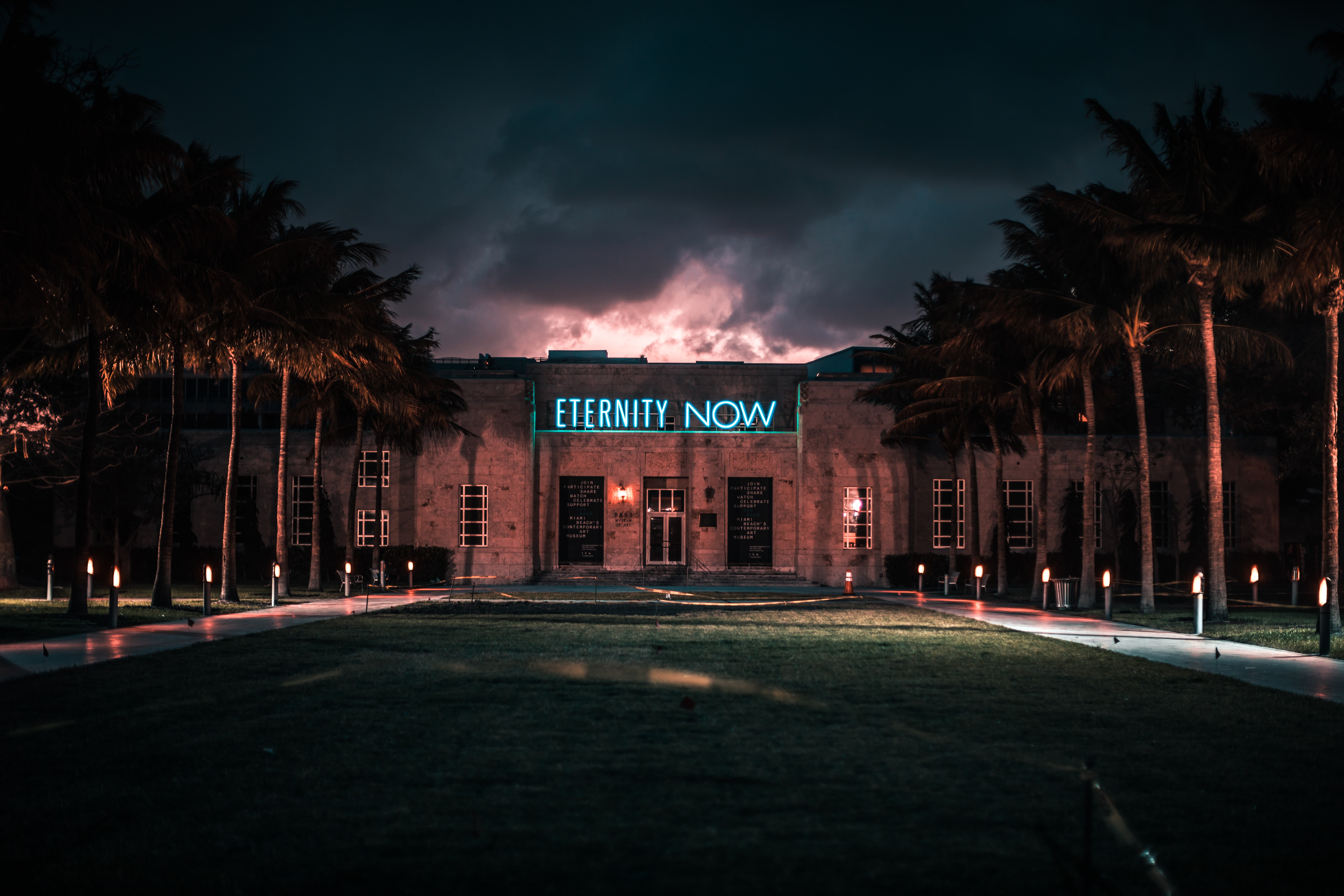 Building with "Eternity Now" neon sign at night HD Wallpaper