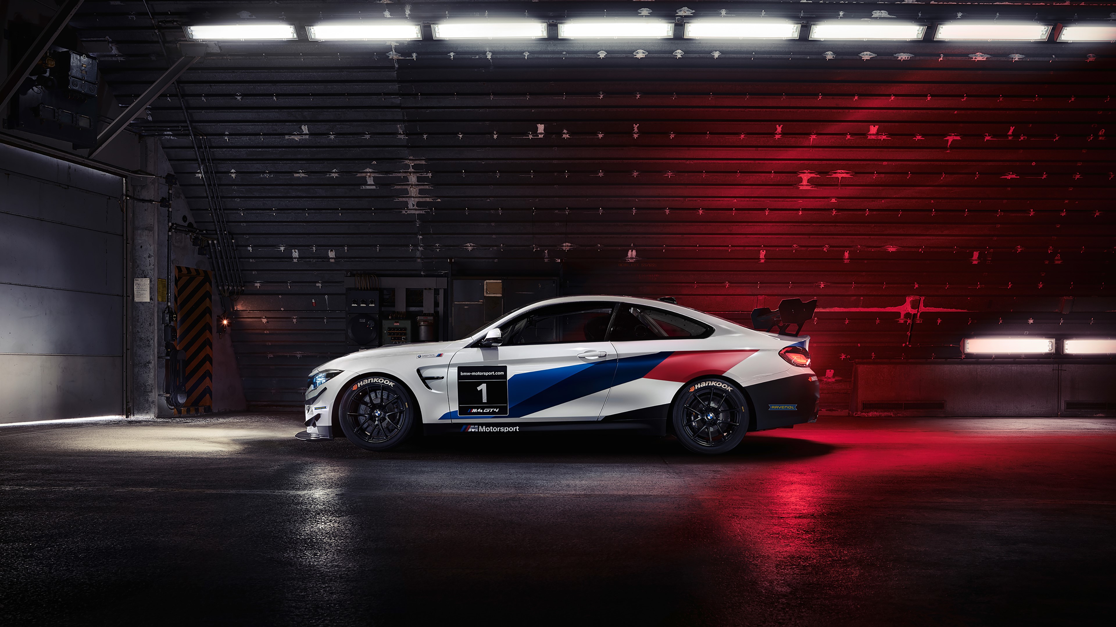 BMW M4 GT4 race car in hangar HD Wallpaper